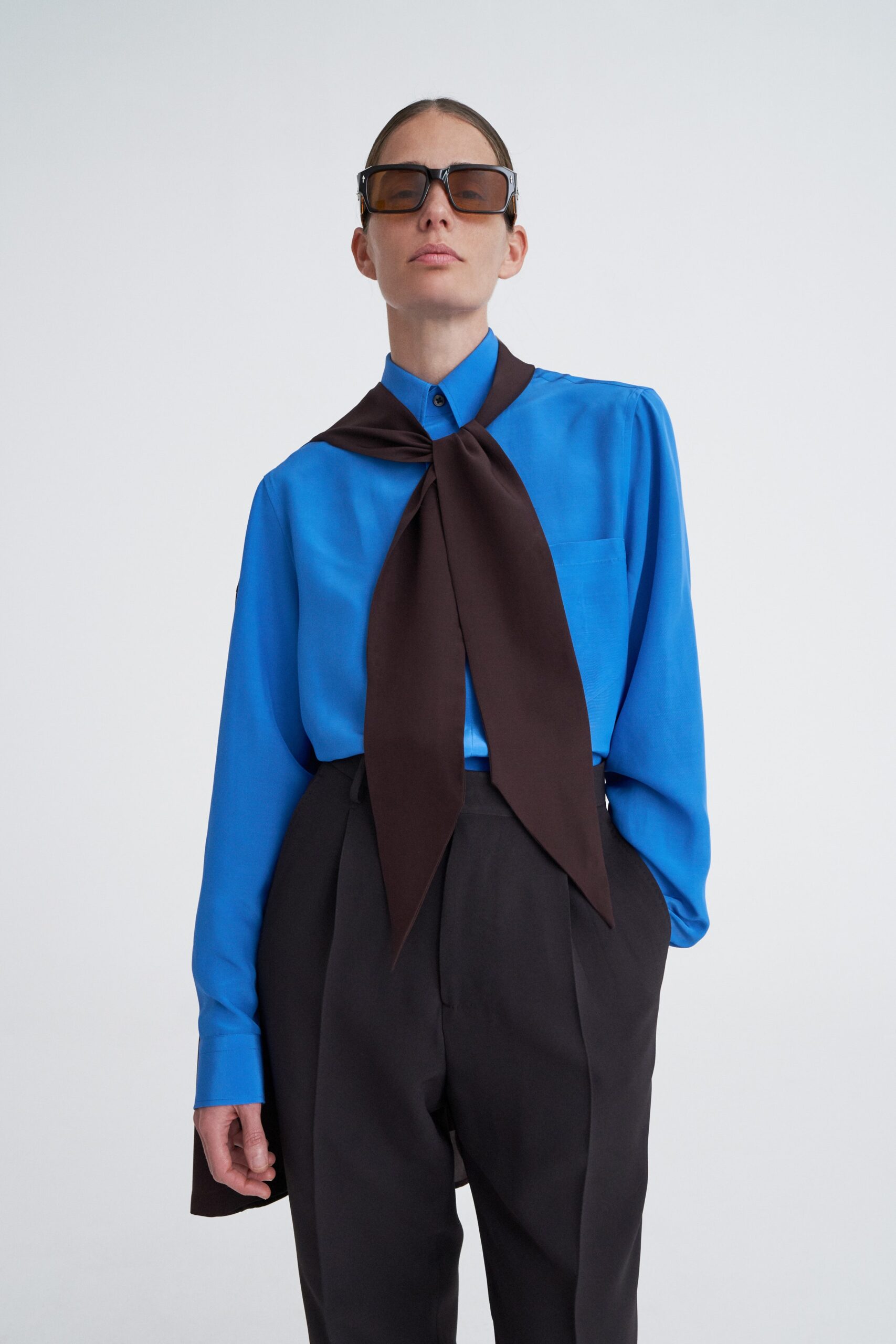 blue fitted shirt with black pants