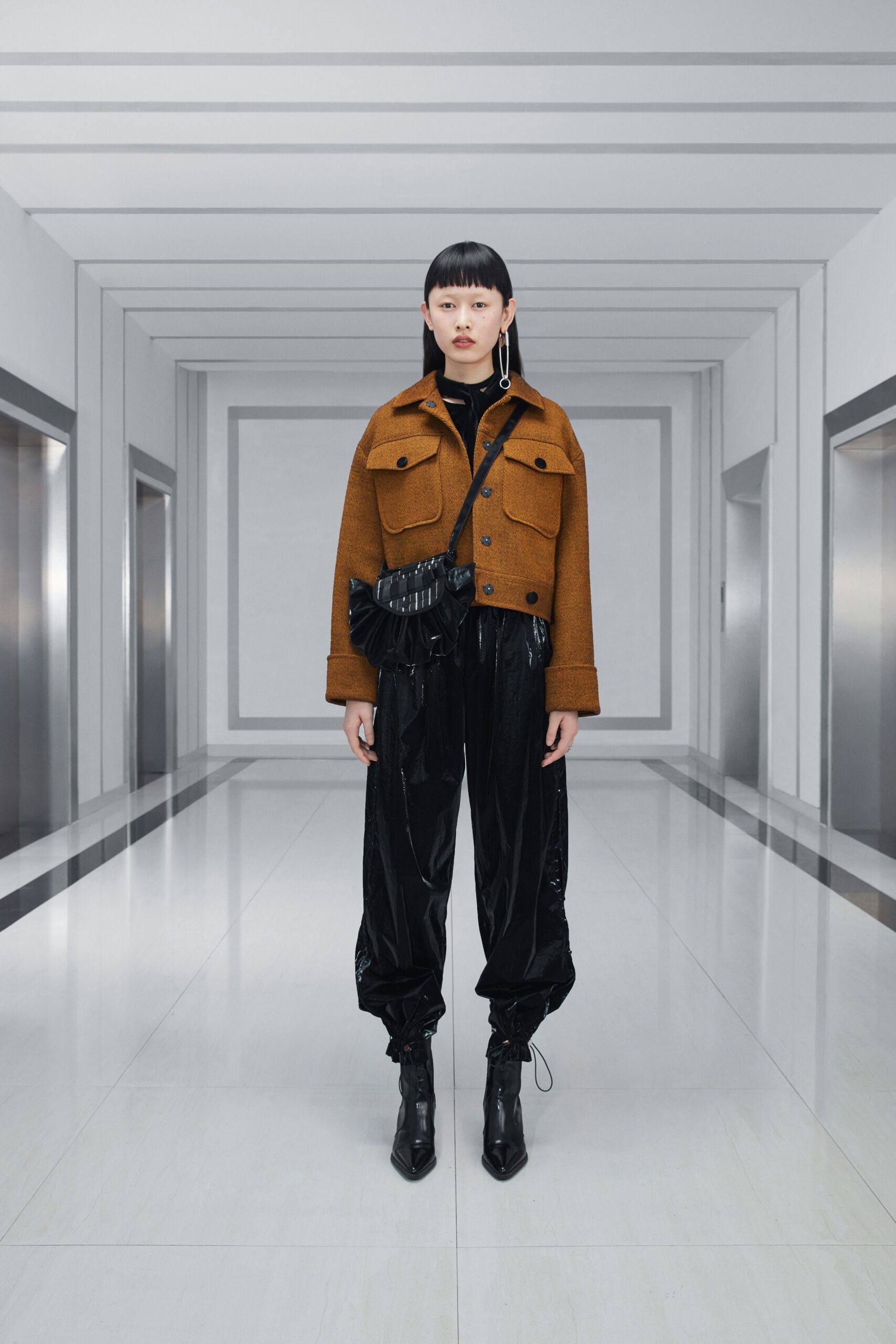 brown jacket black vinyl pants