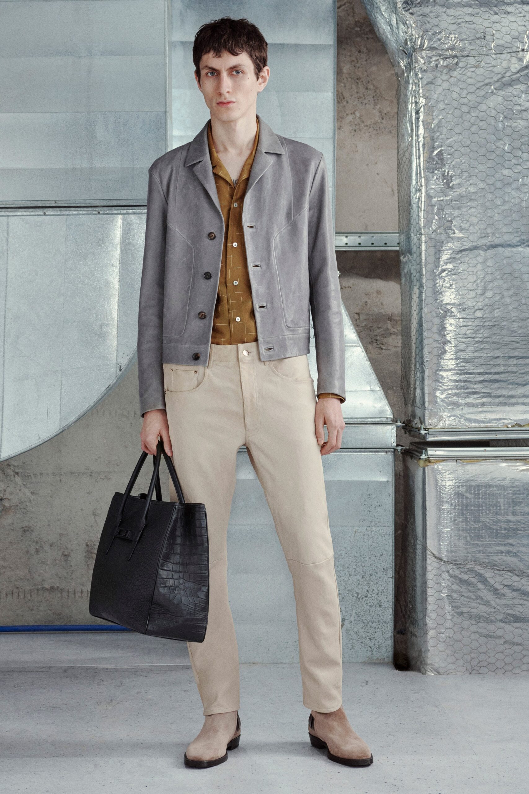 gray leather jacket with beige pants