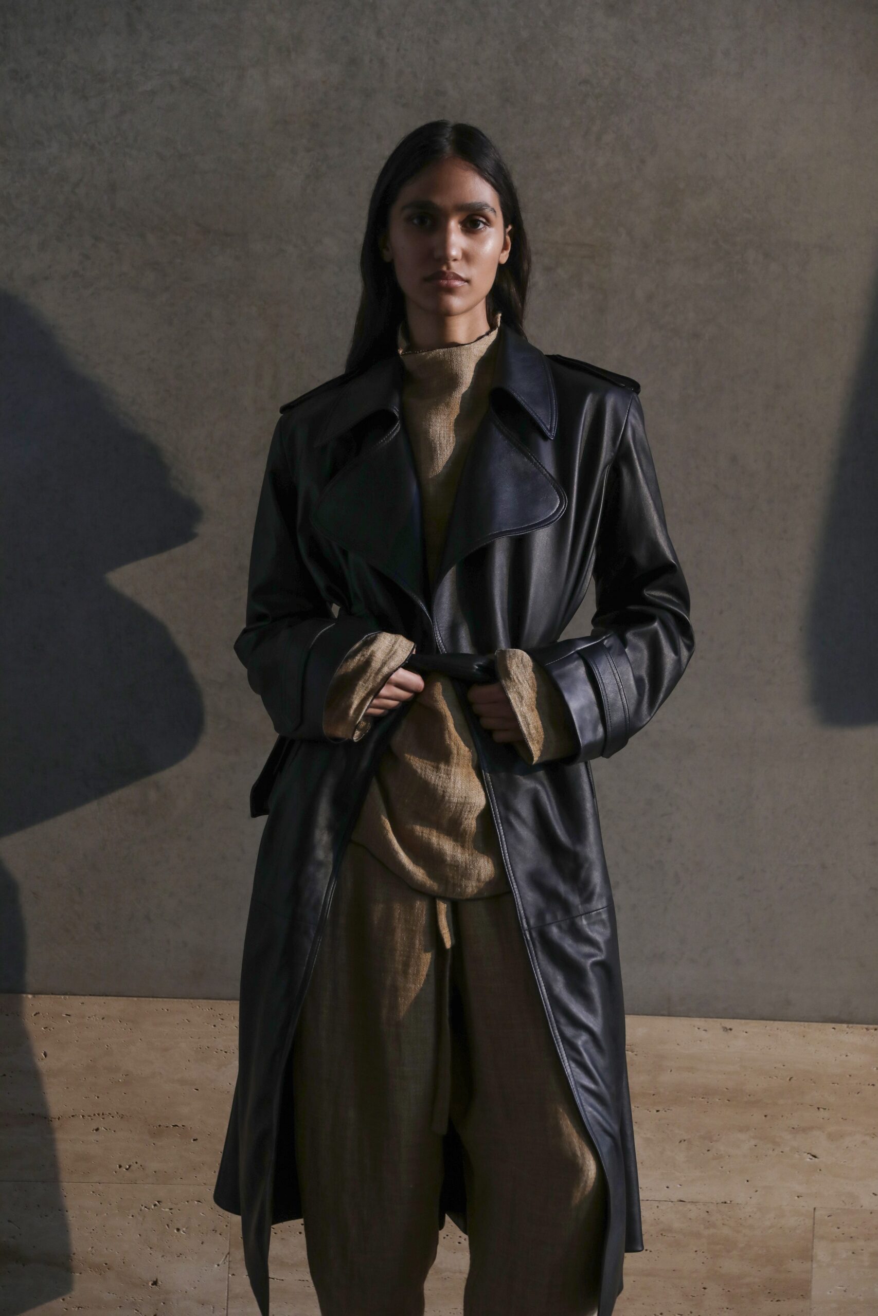 black leather coat with beige top