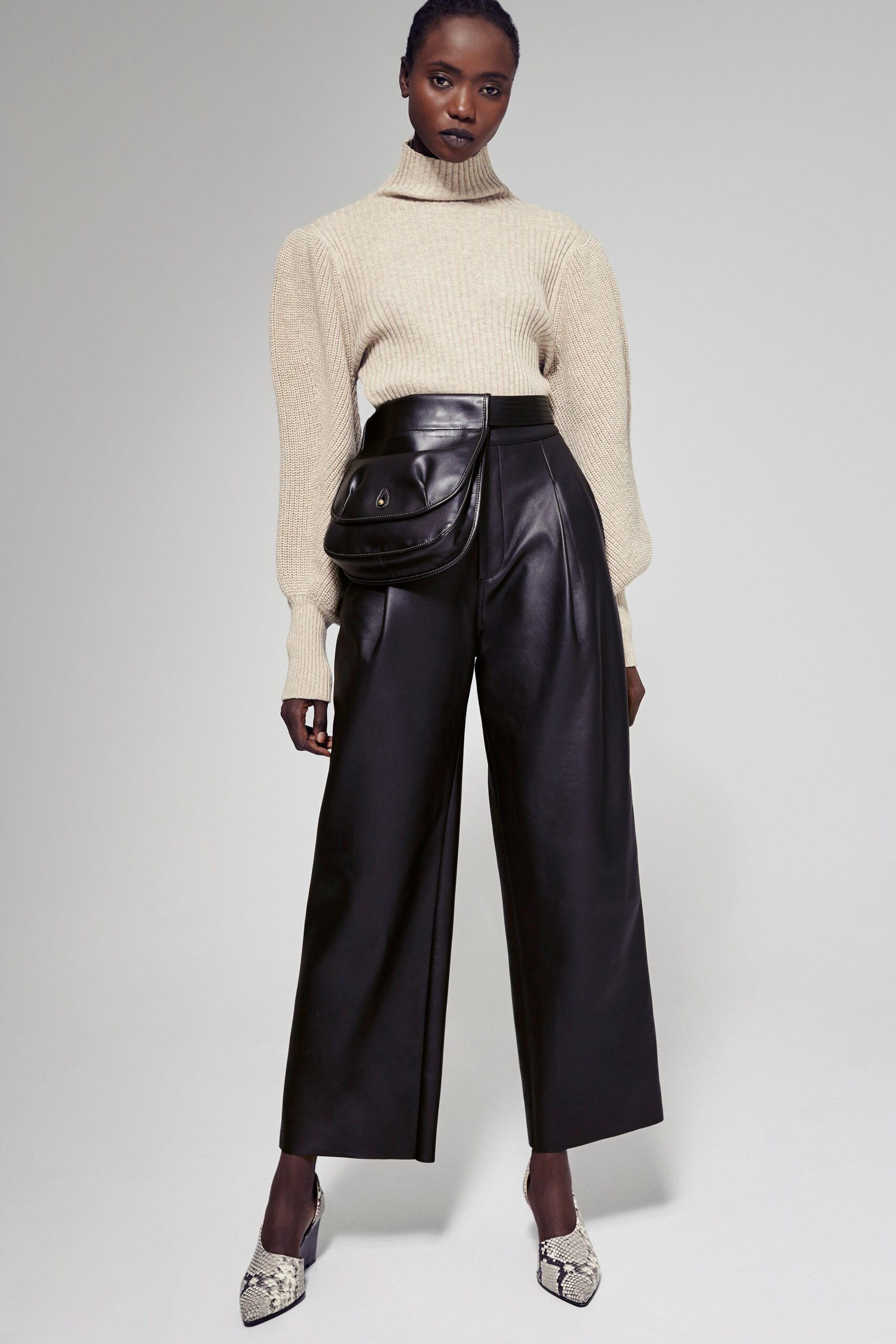 beige wool turtleneck sweater and black leather pants