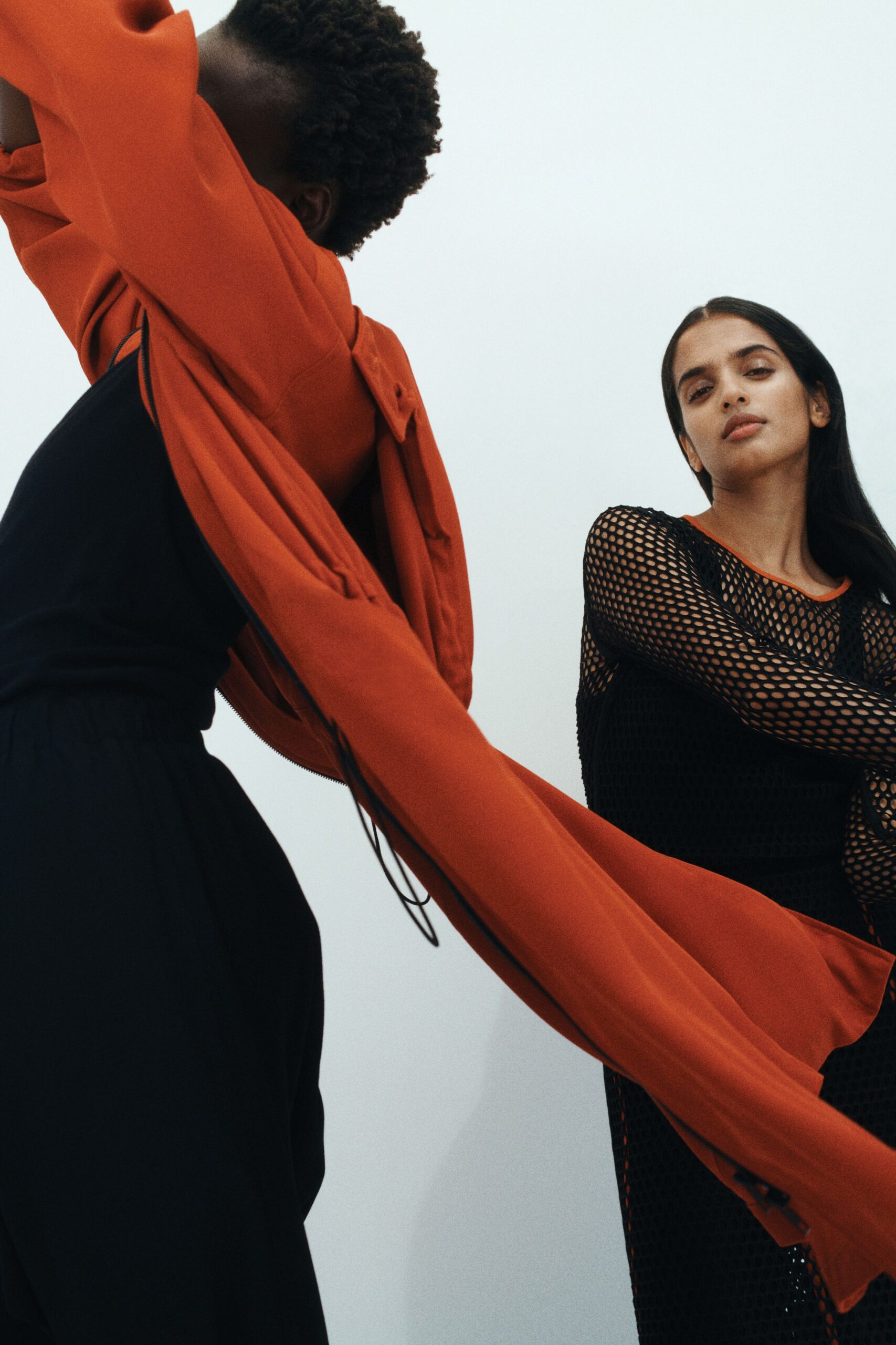 black fitted dress and oversized red jacket