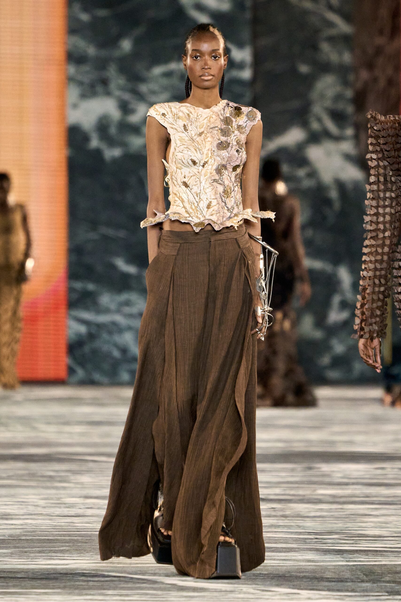 beige embroidered sleeveless top and brown wide-leg pants
