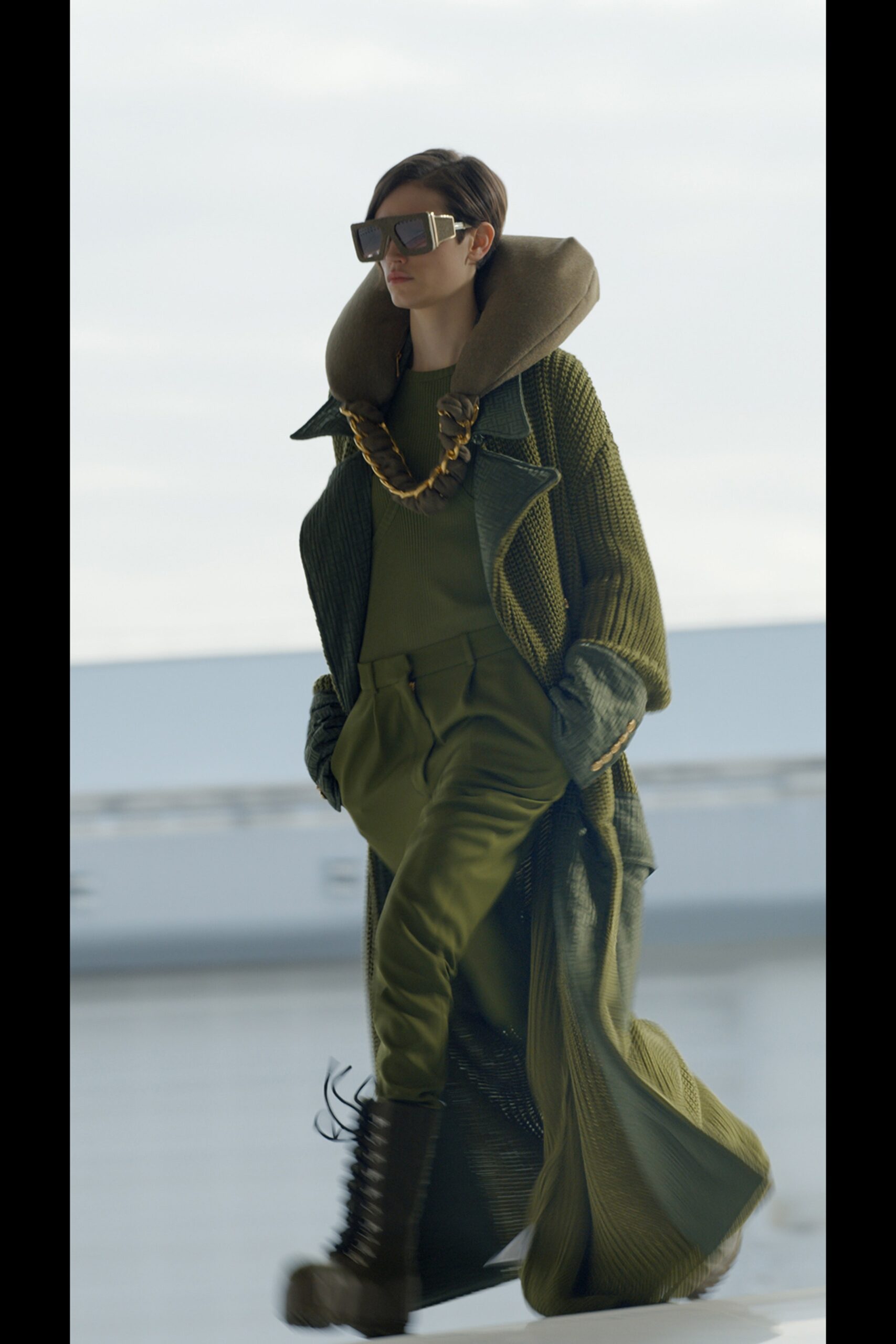 green knit coat with sunglasses