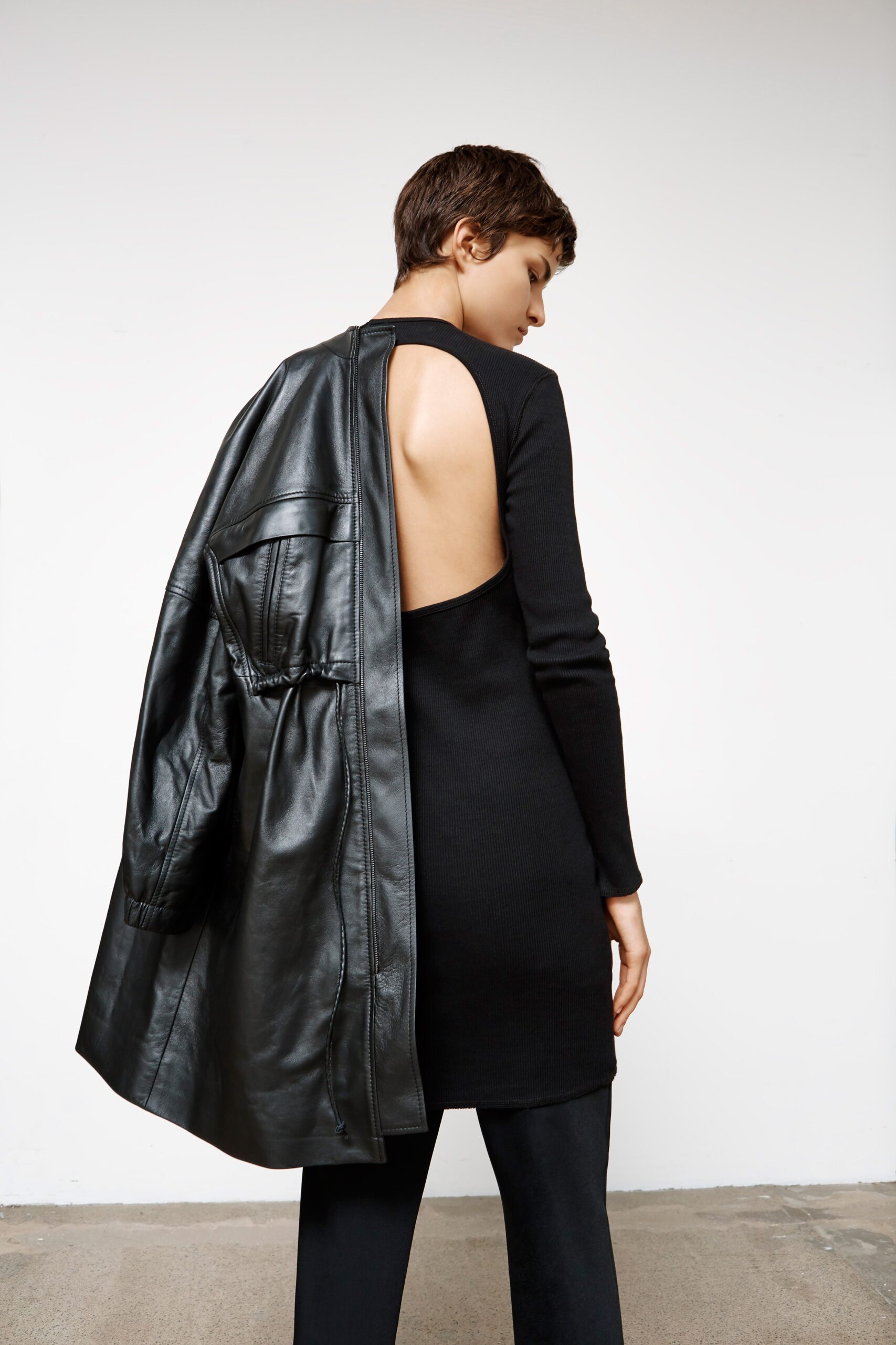 black fitted midi dress with leather coat