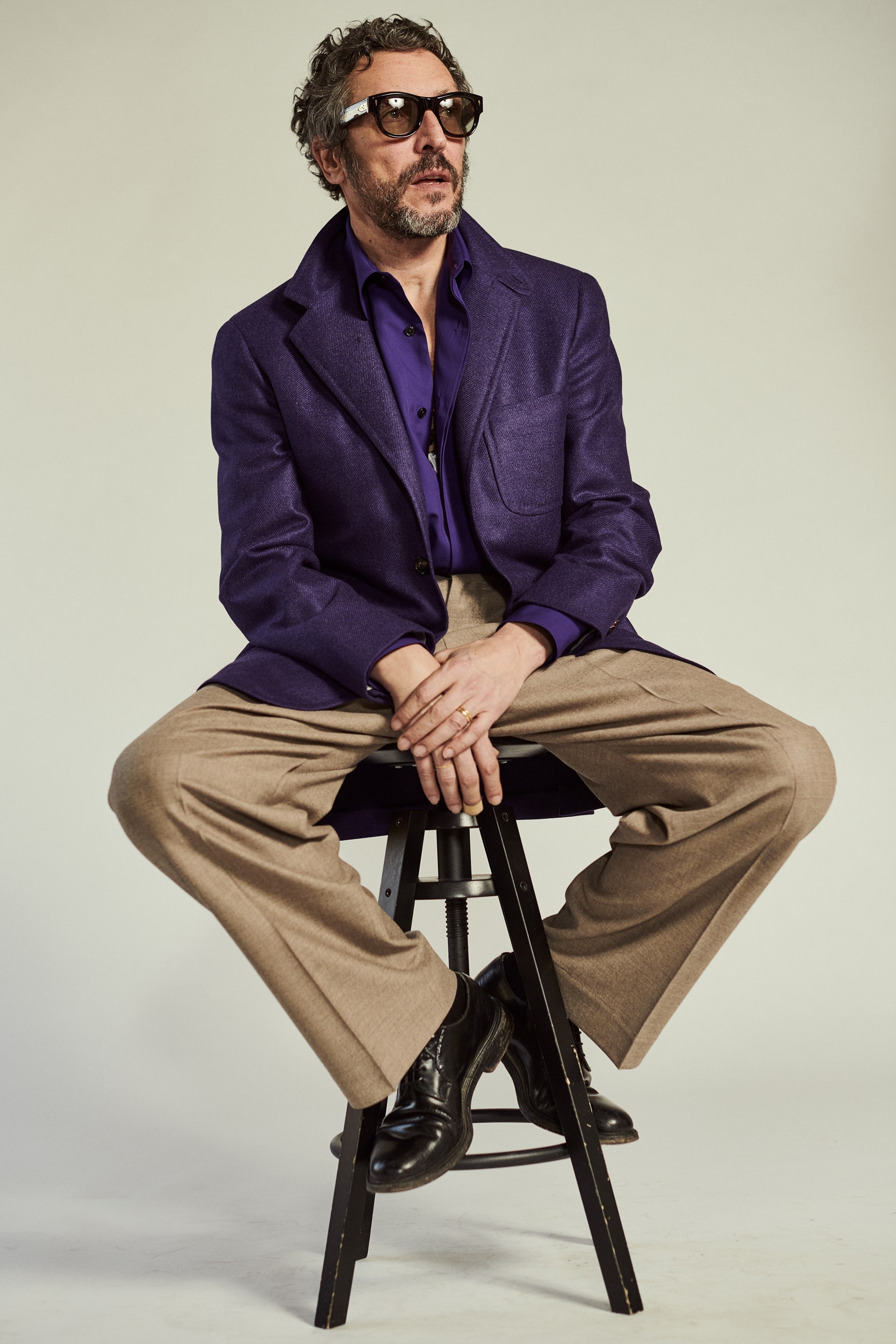 purple tailored blazer with beige pants