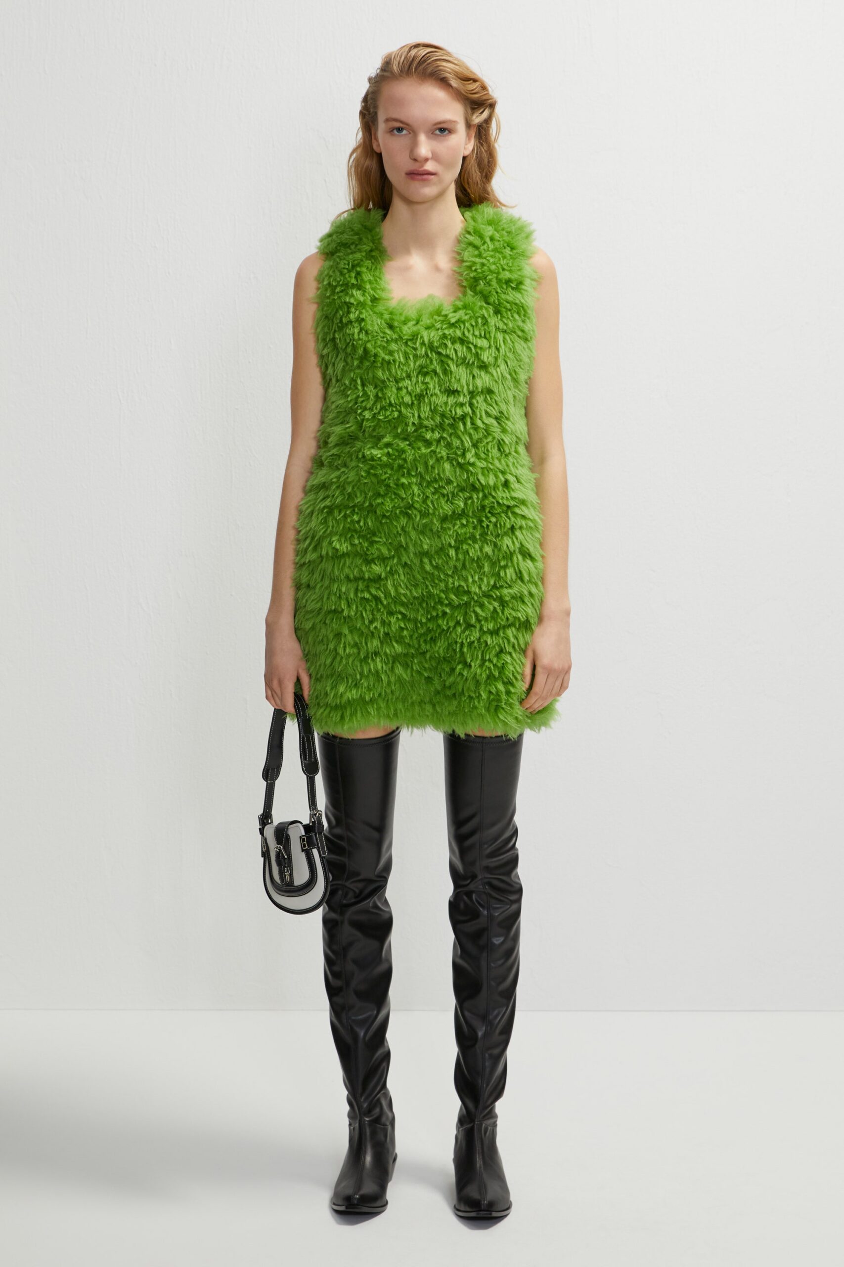 green faux-fur mini dress with black boots