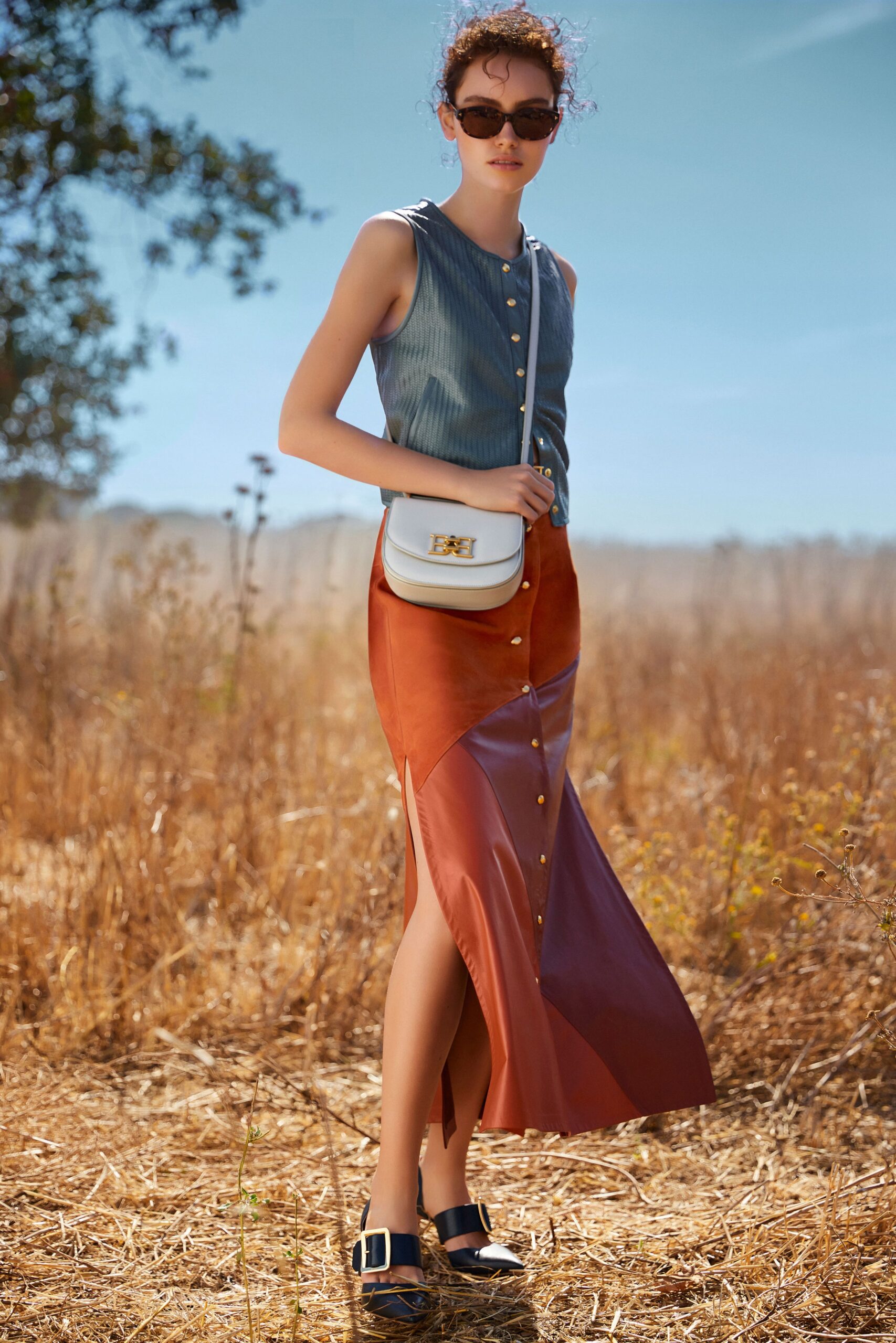 blue fitted top with orange leather skirt