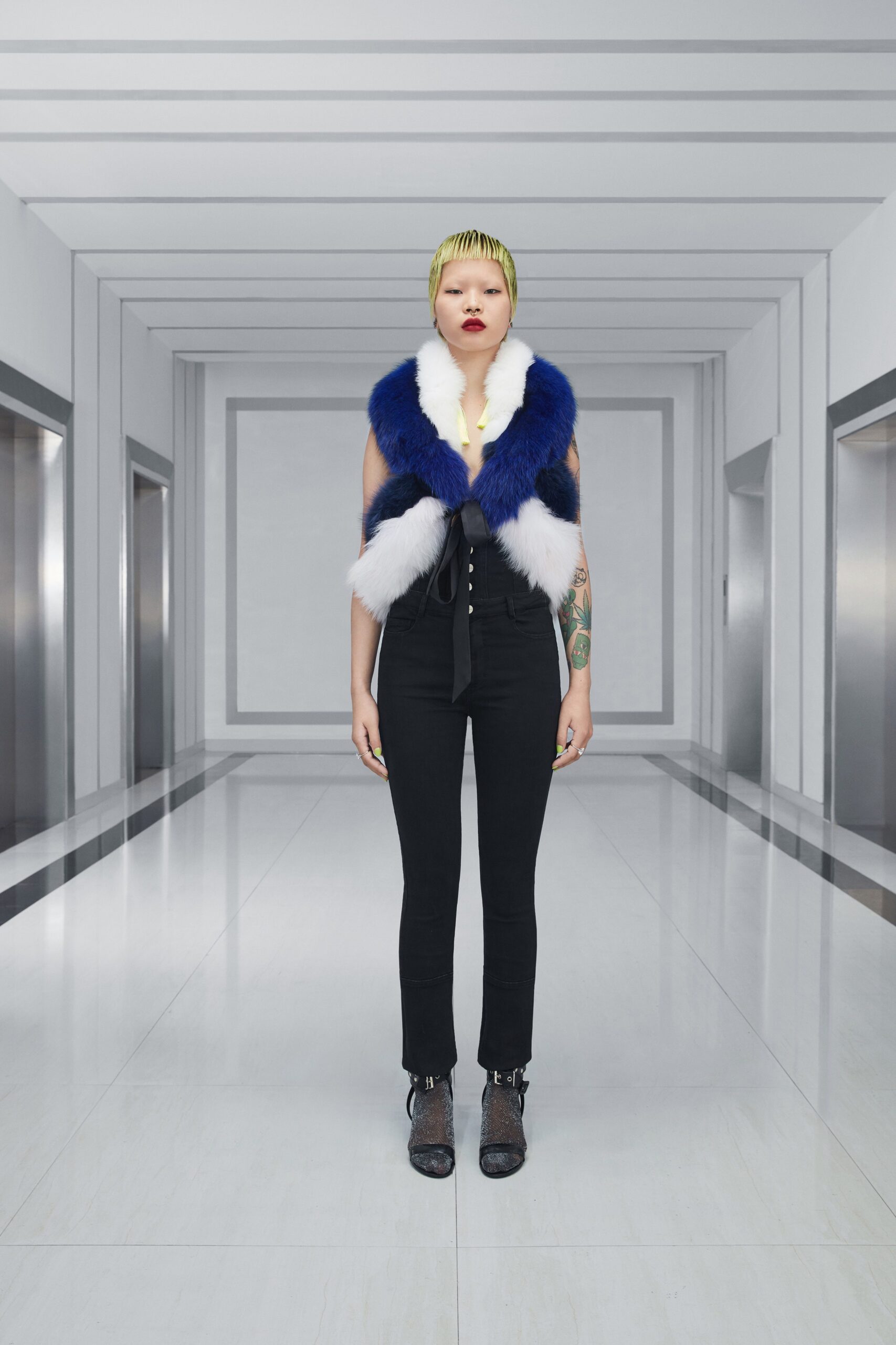 blue fur vest and black pants