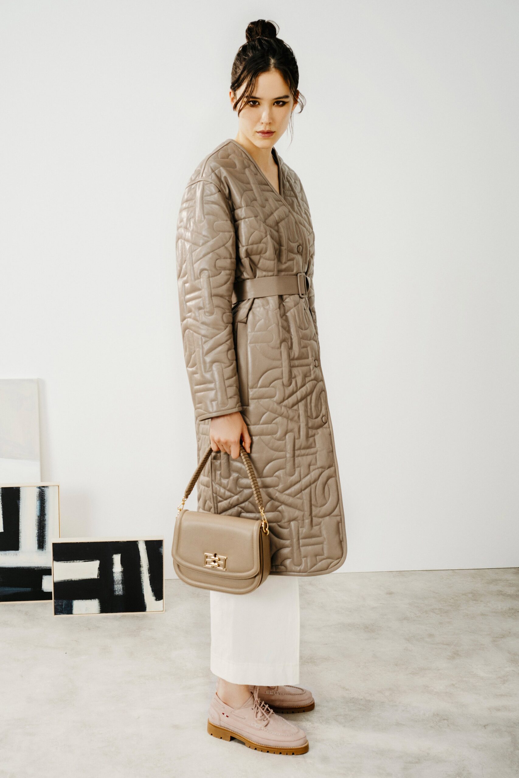 beige quilted coat with white pants