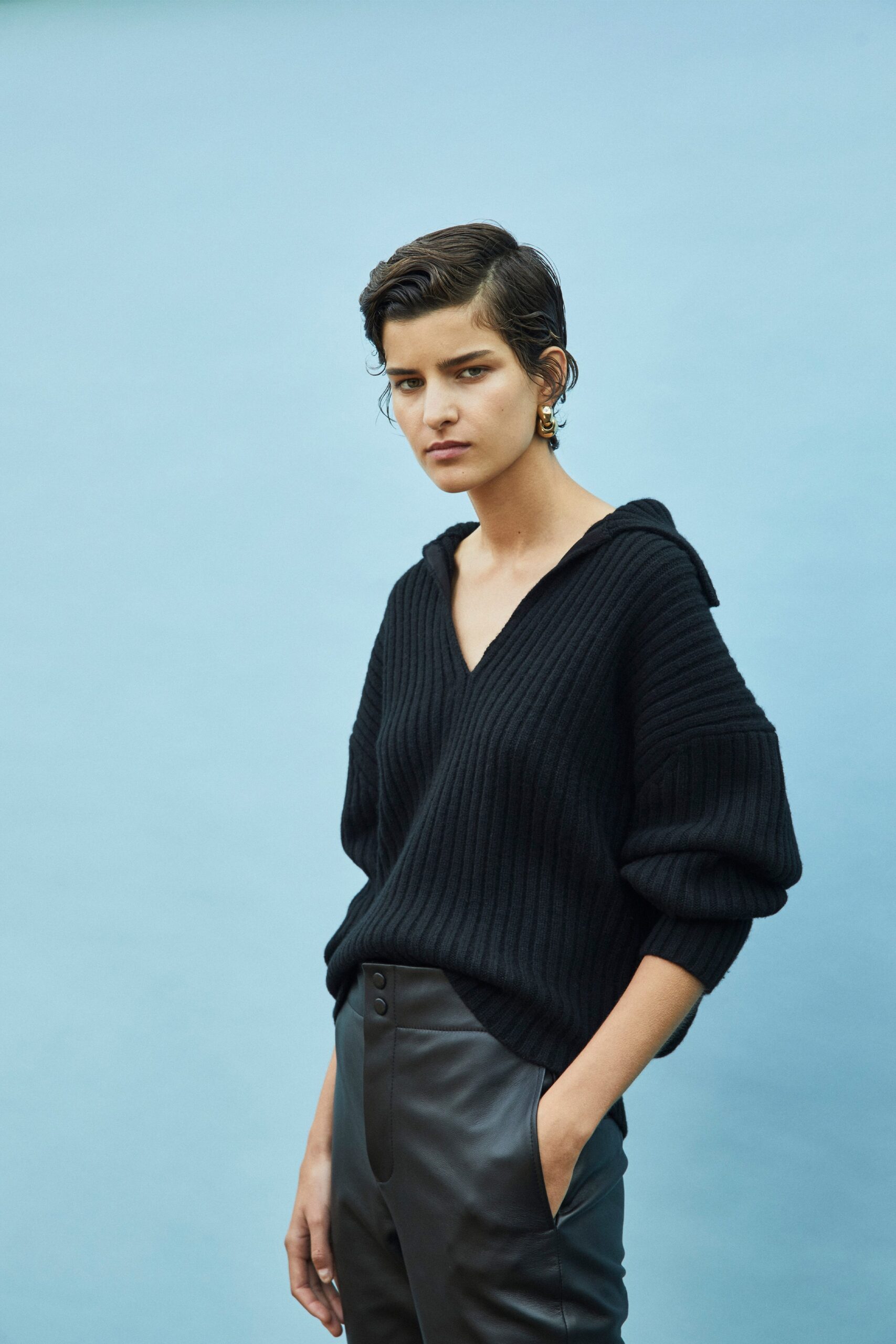 black relaxed sweater and fitted pants