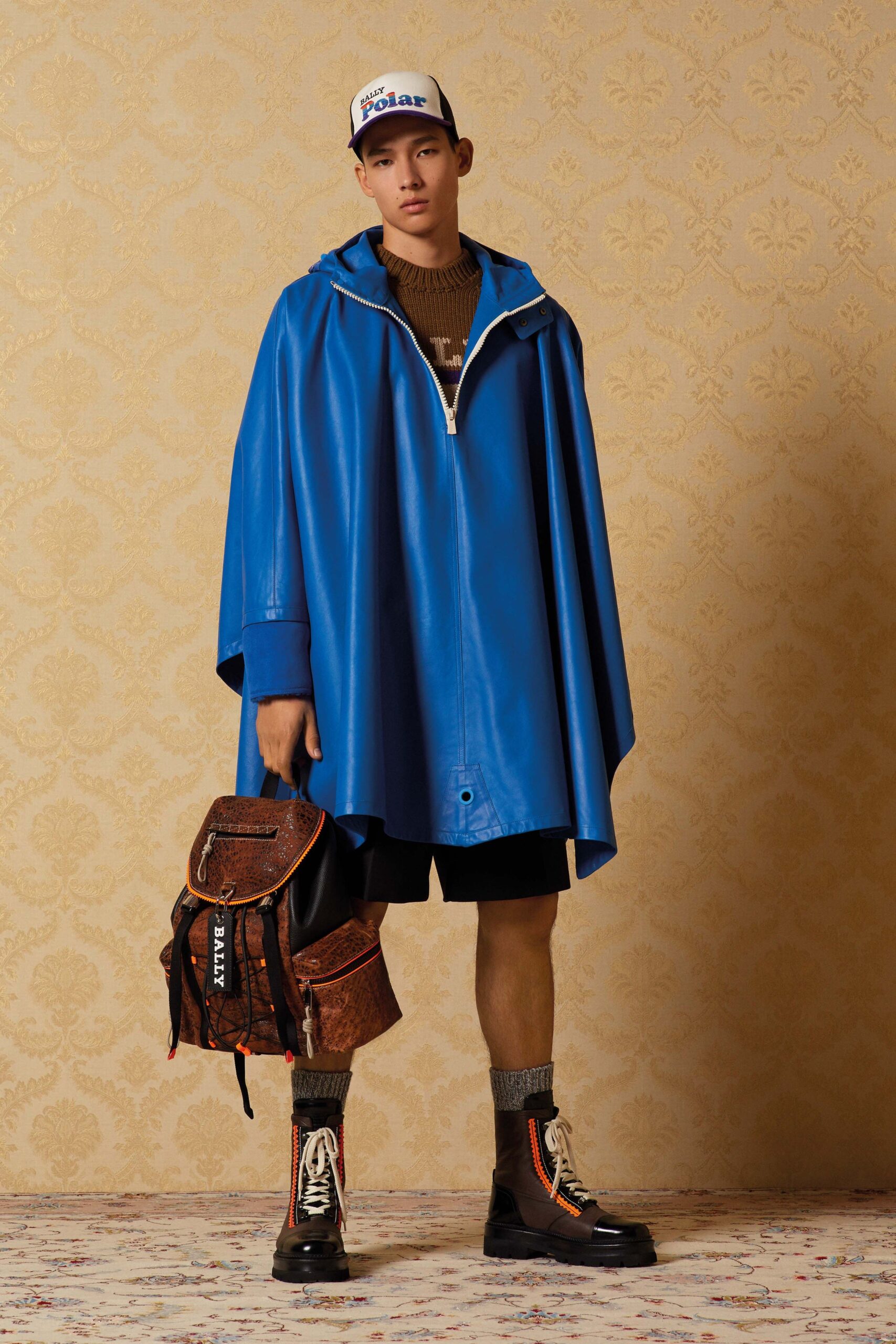 blue leather poncho with black shorts