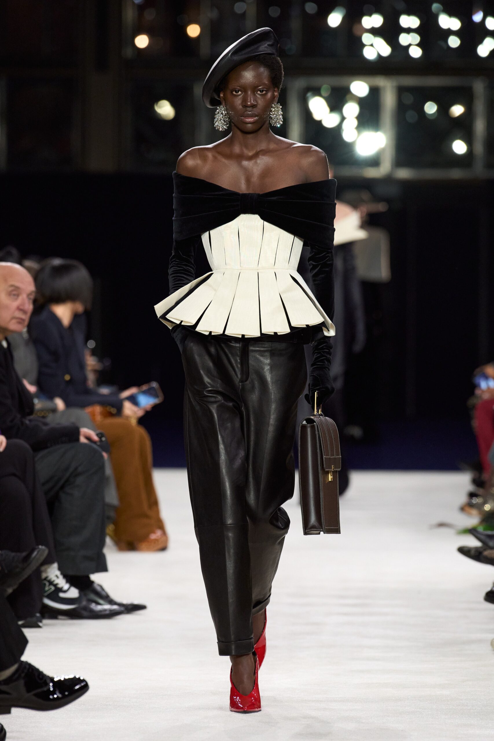 black and white off-shoulder top with leather pants