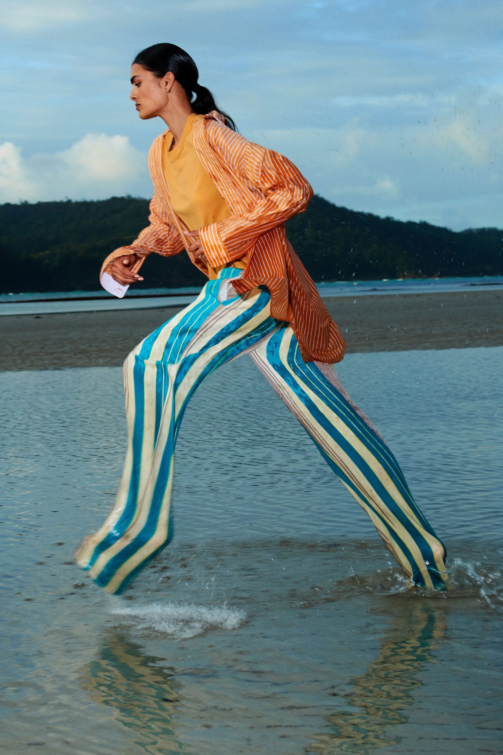 striped orange top and blue pants