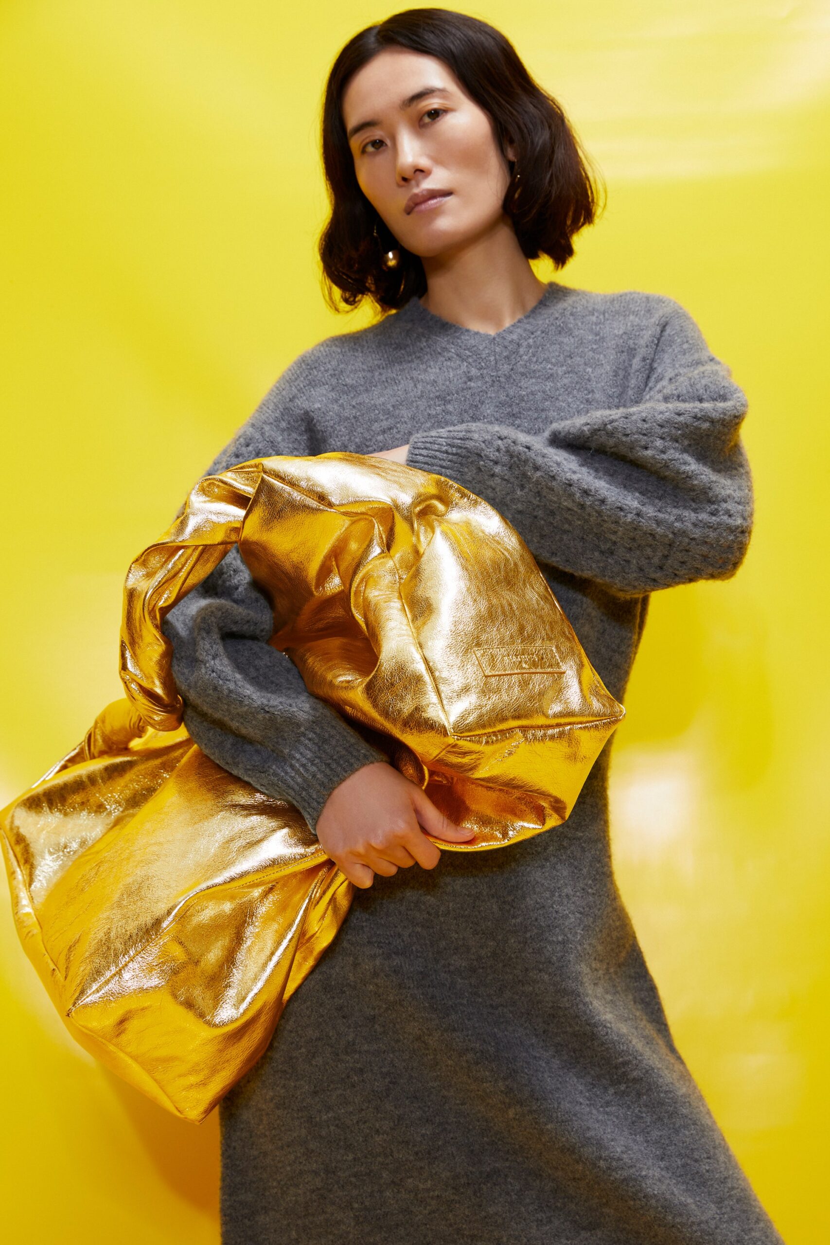 gray wool midi dress with gold bag