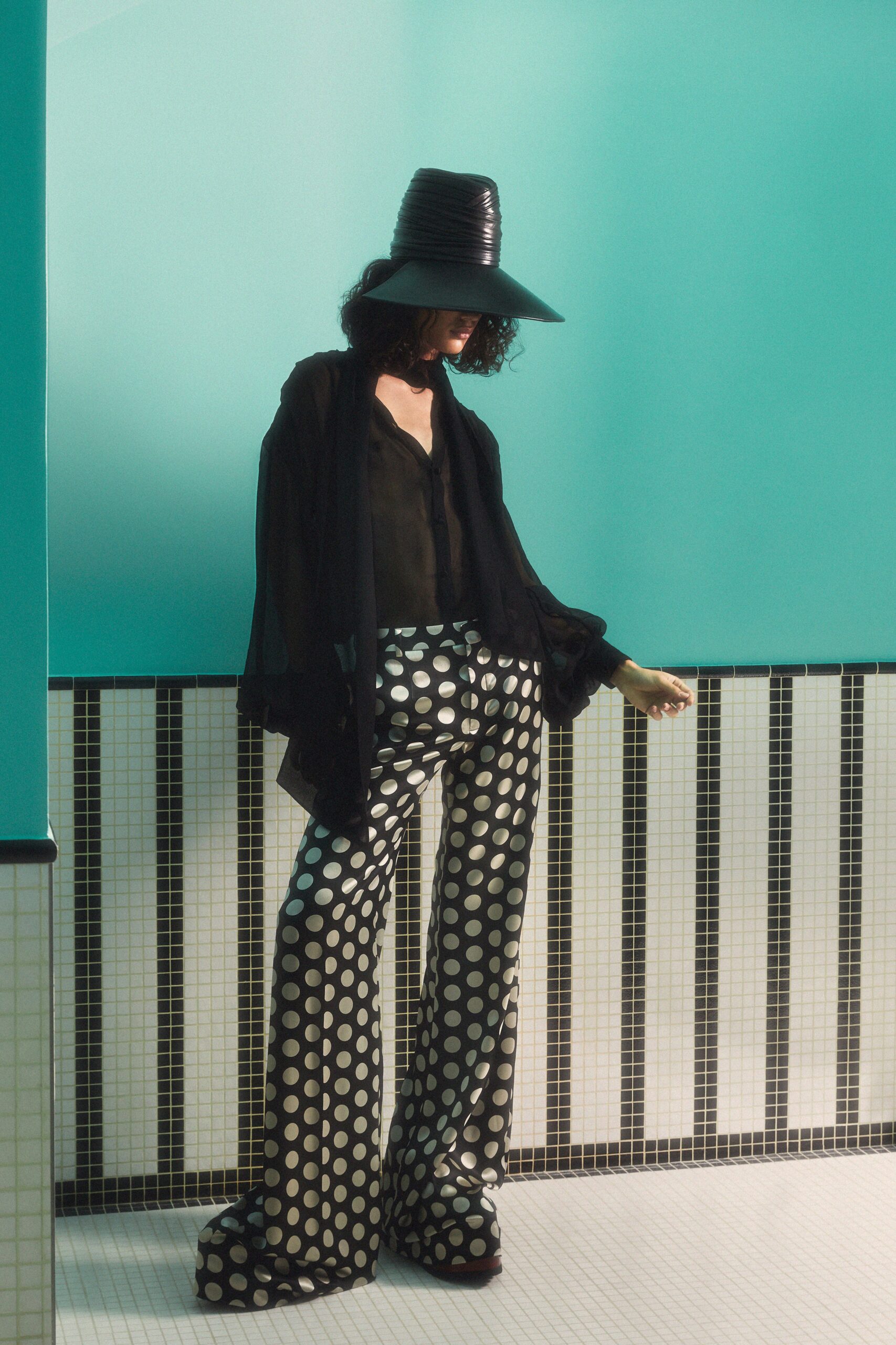 black sheer blouse with polka-dot pants