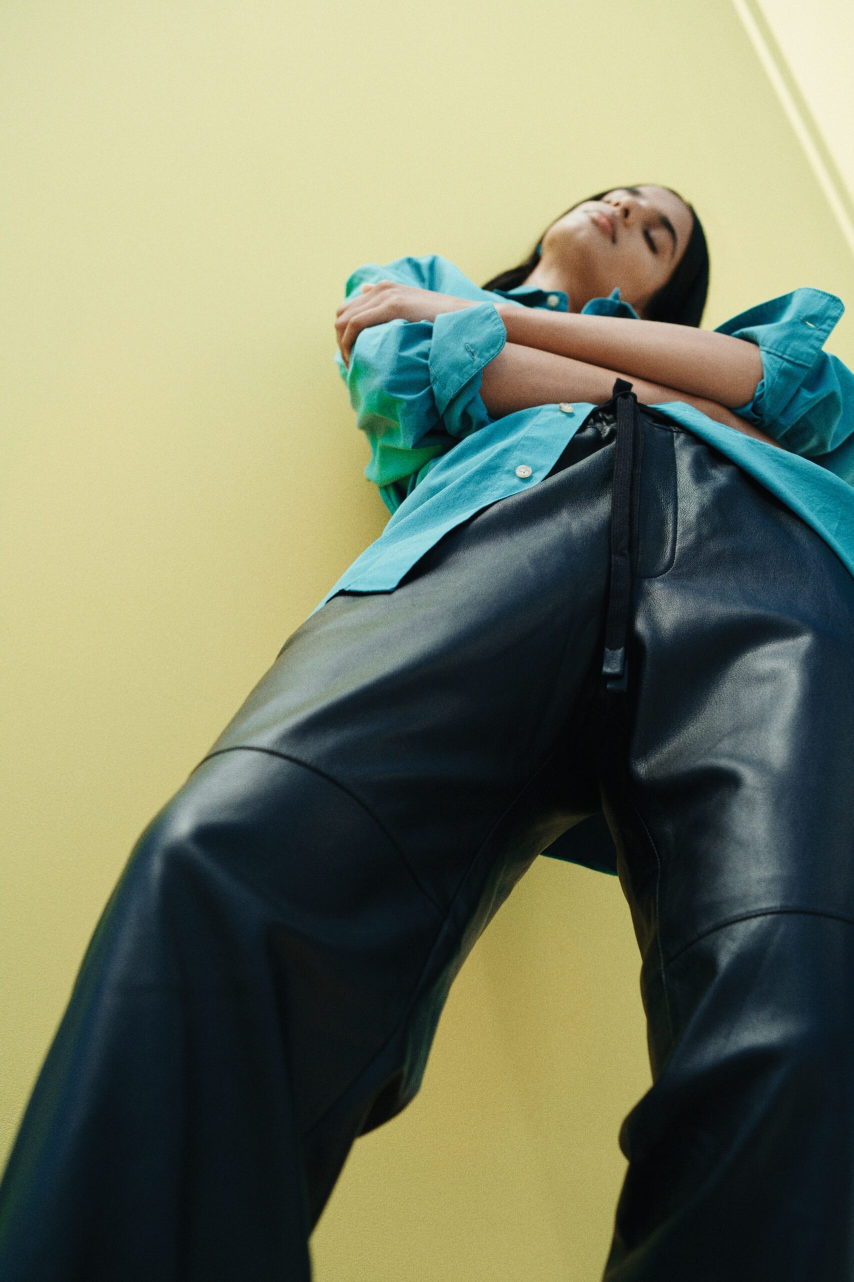 blue relaxed shirt and black leather pants