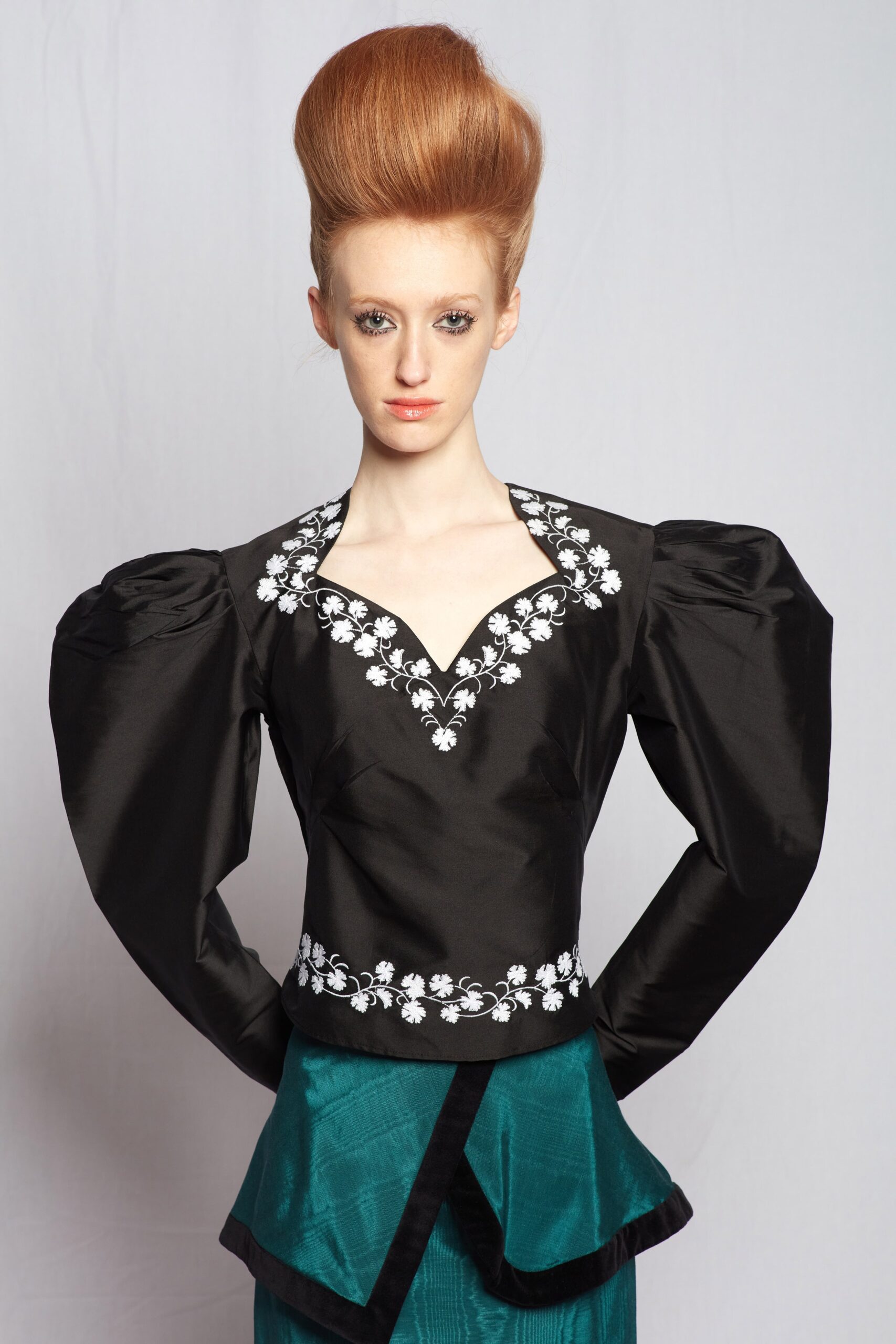 black silk embroidered blouse and teal skirt