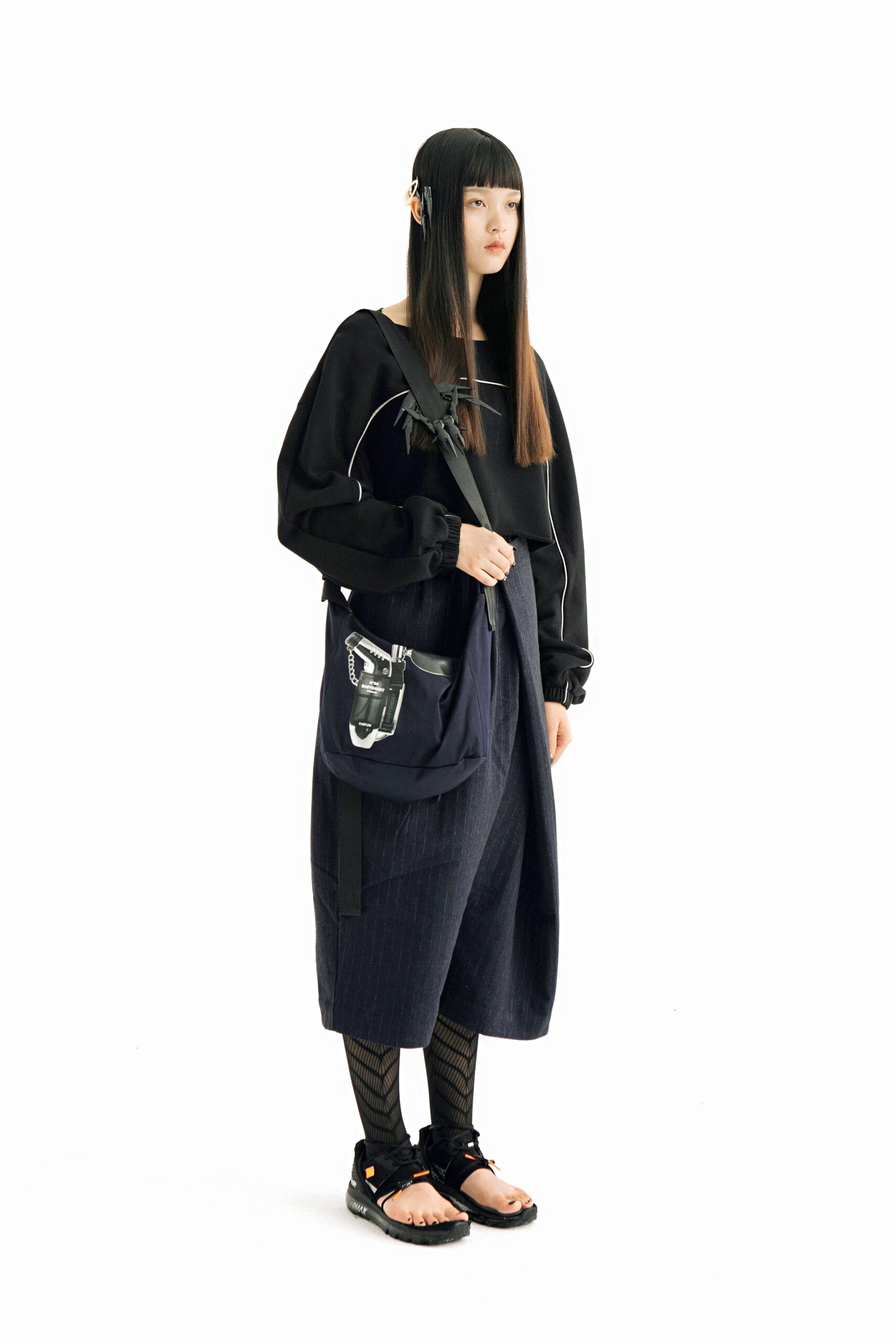 black relaxed top with blue pants