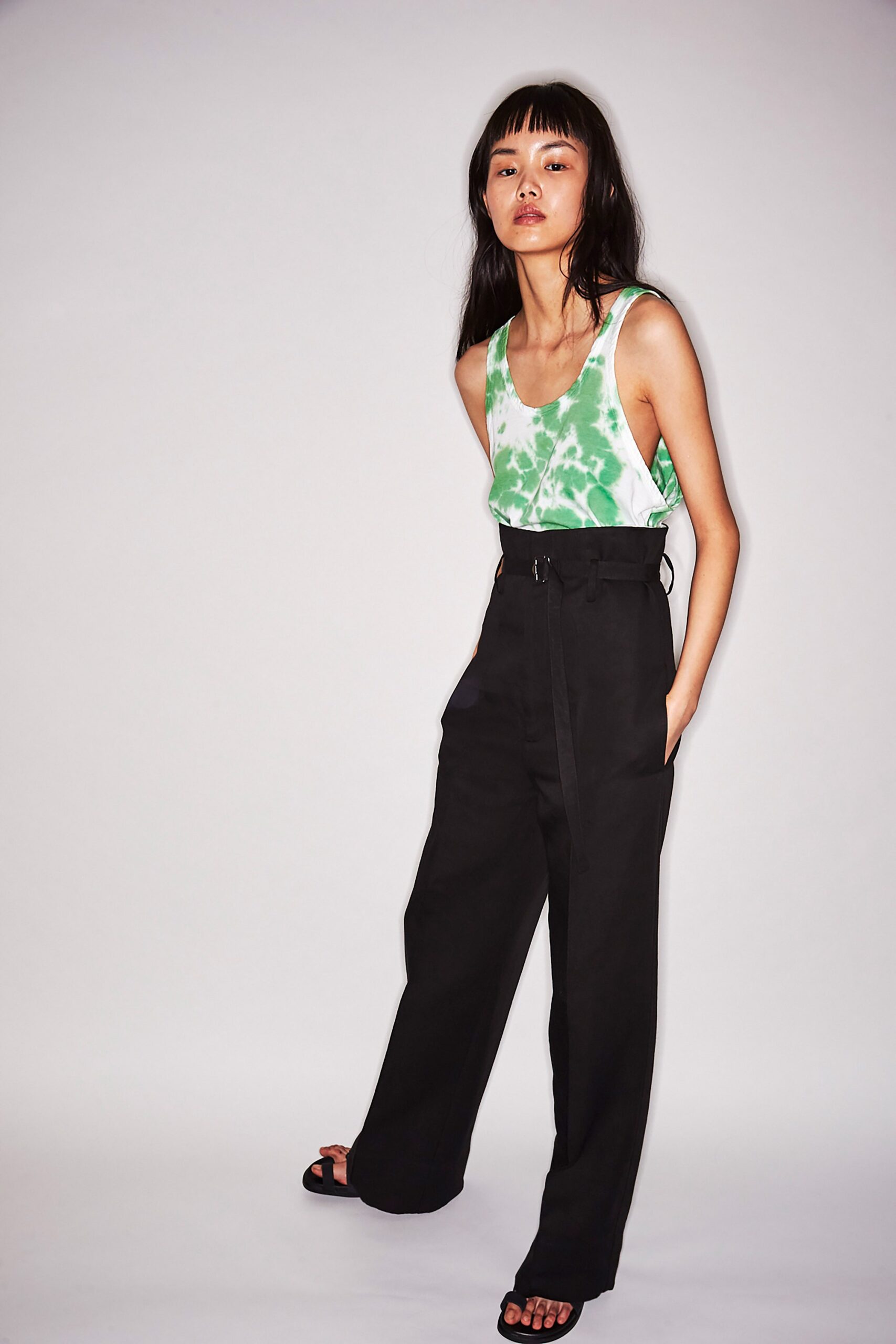 green tie-dye tank-top and black pants