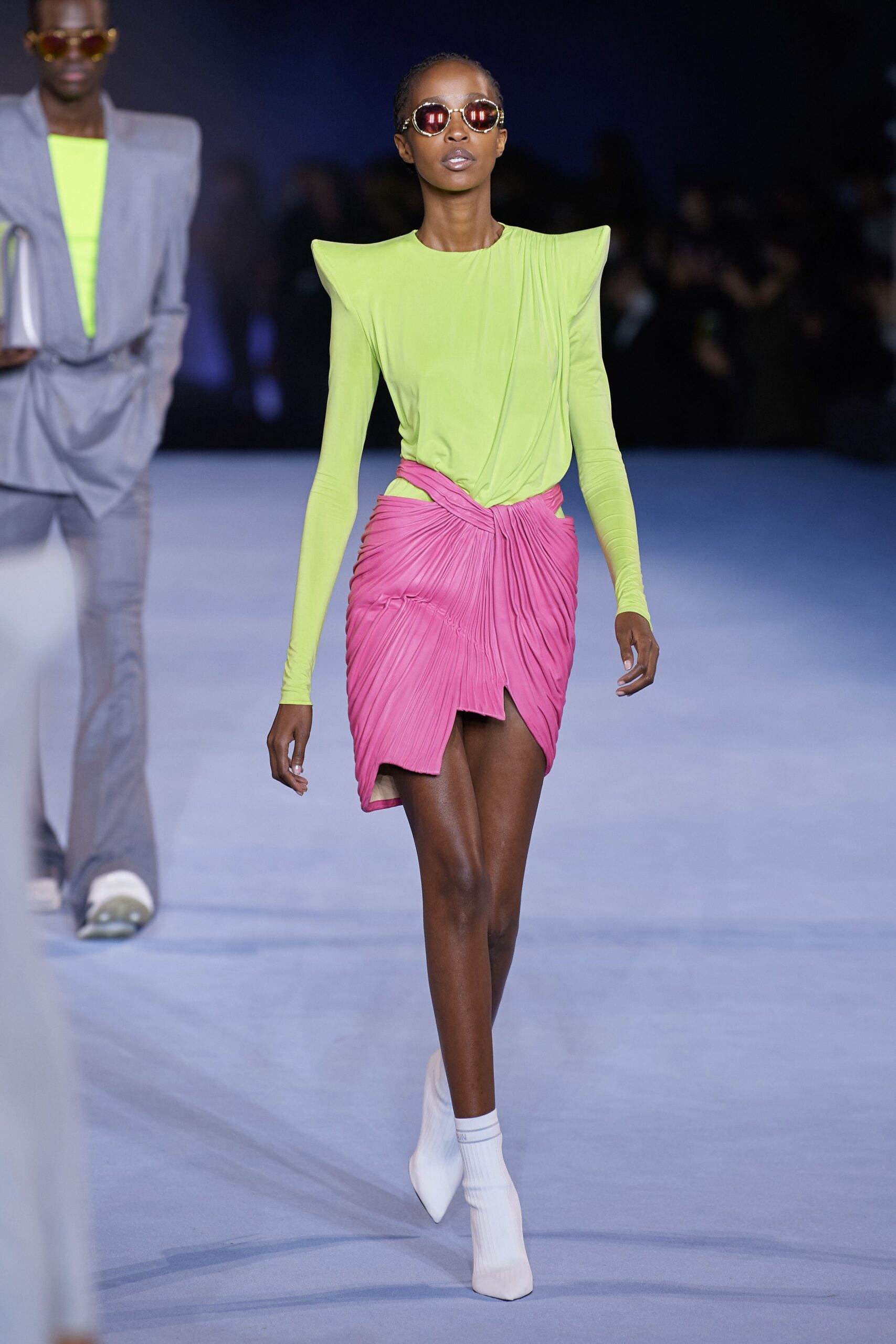neon green fitted top with pleated pink skirt