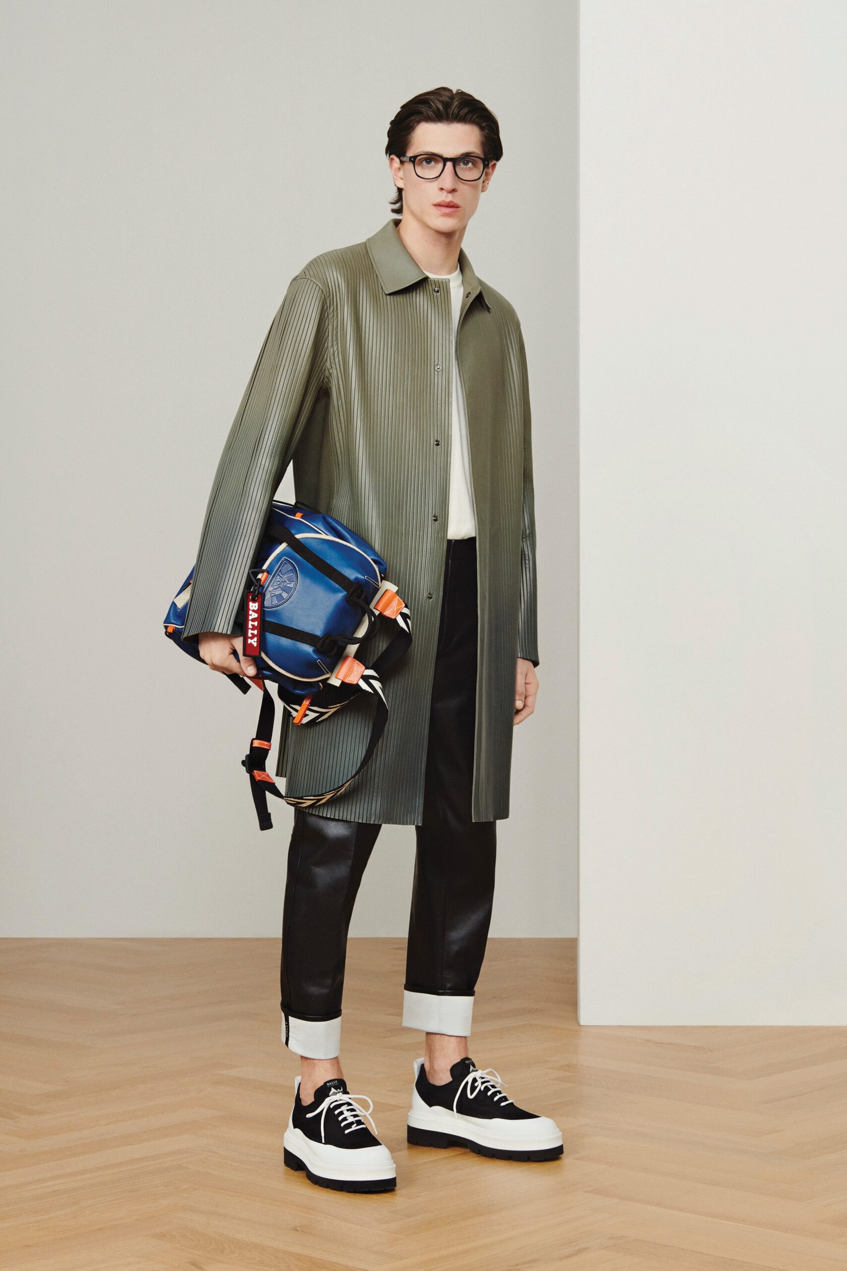 green vinyl coat with black pants