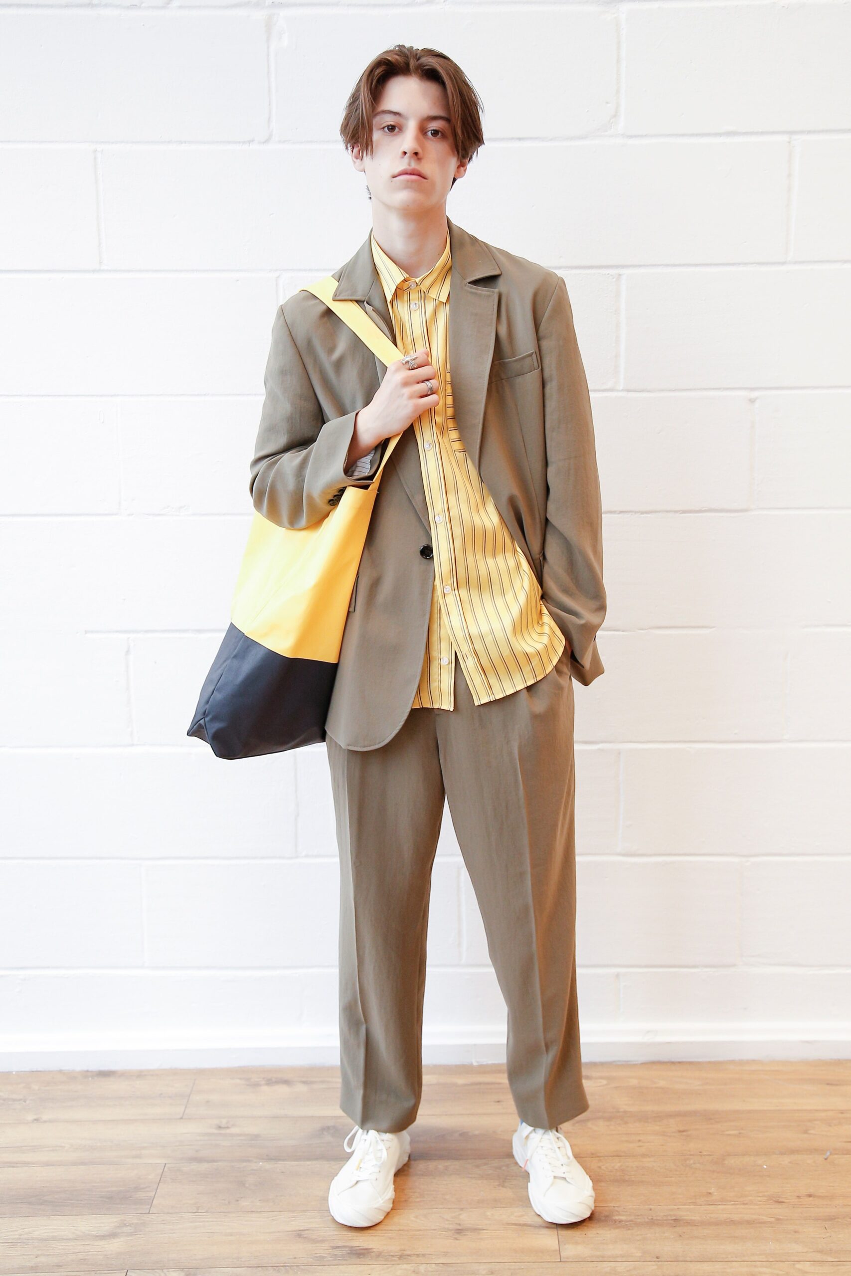 brown relaxed suit with yellow shirt