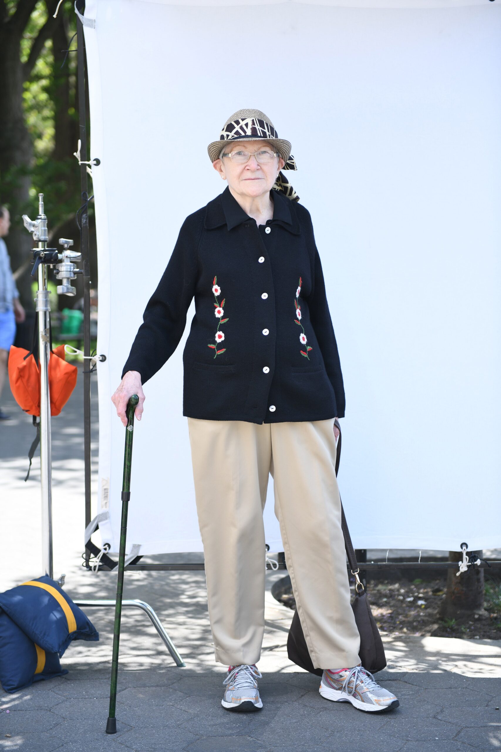 black embroidered jacket with beige pants