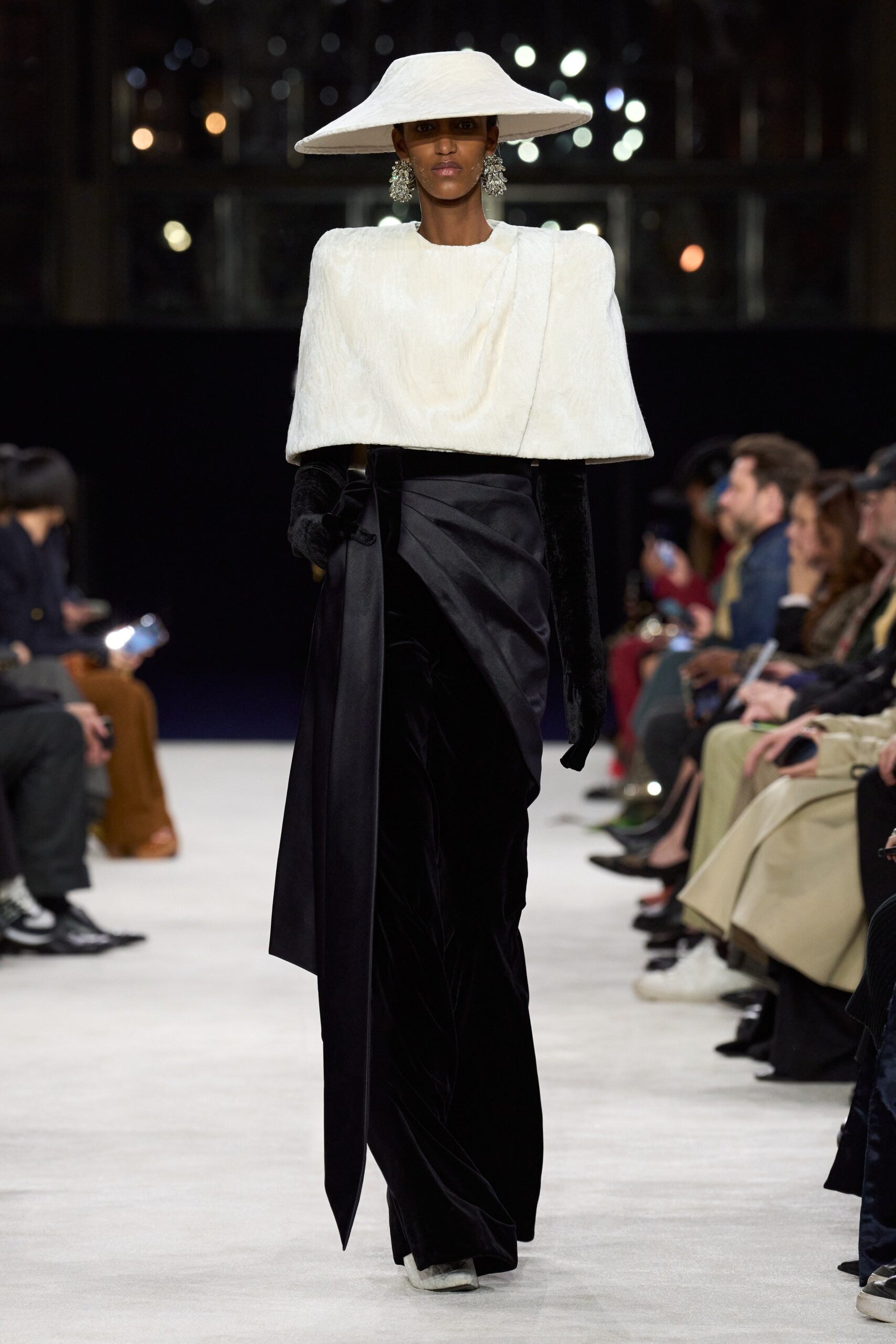 white fur cape and black velvet pants