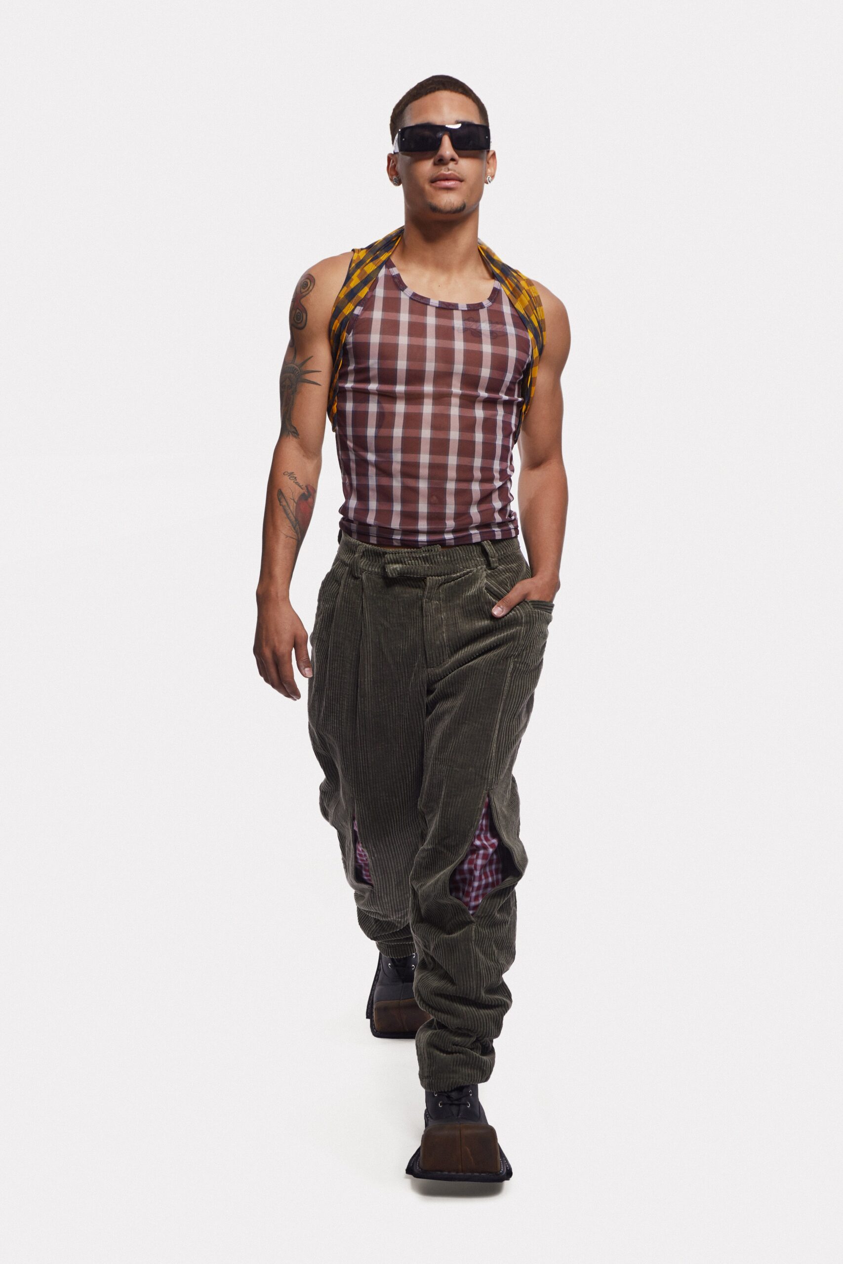 brown checked tank-top and green cargo pants