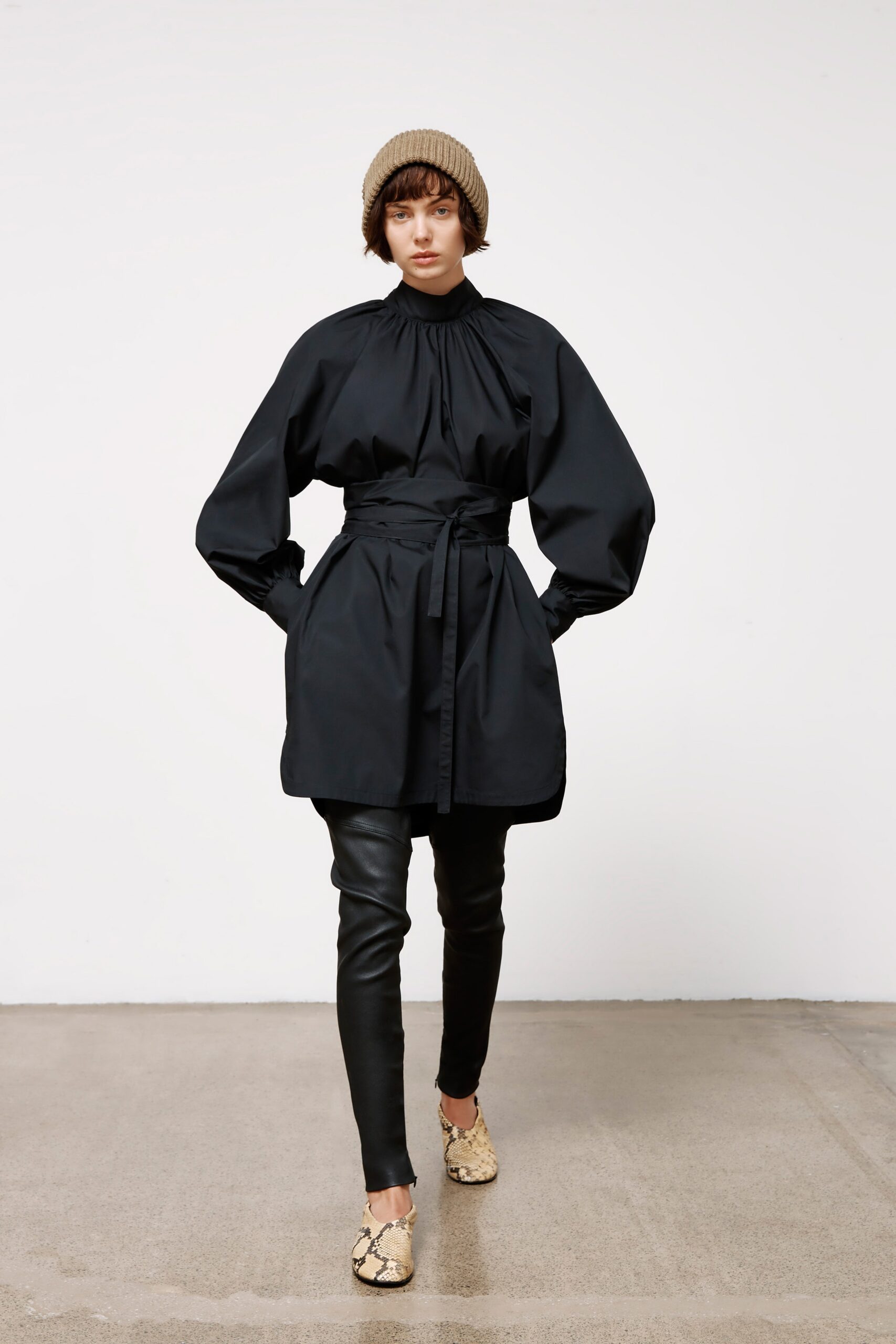 black fitted coat and leather pants