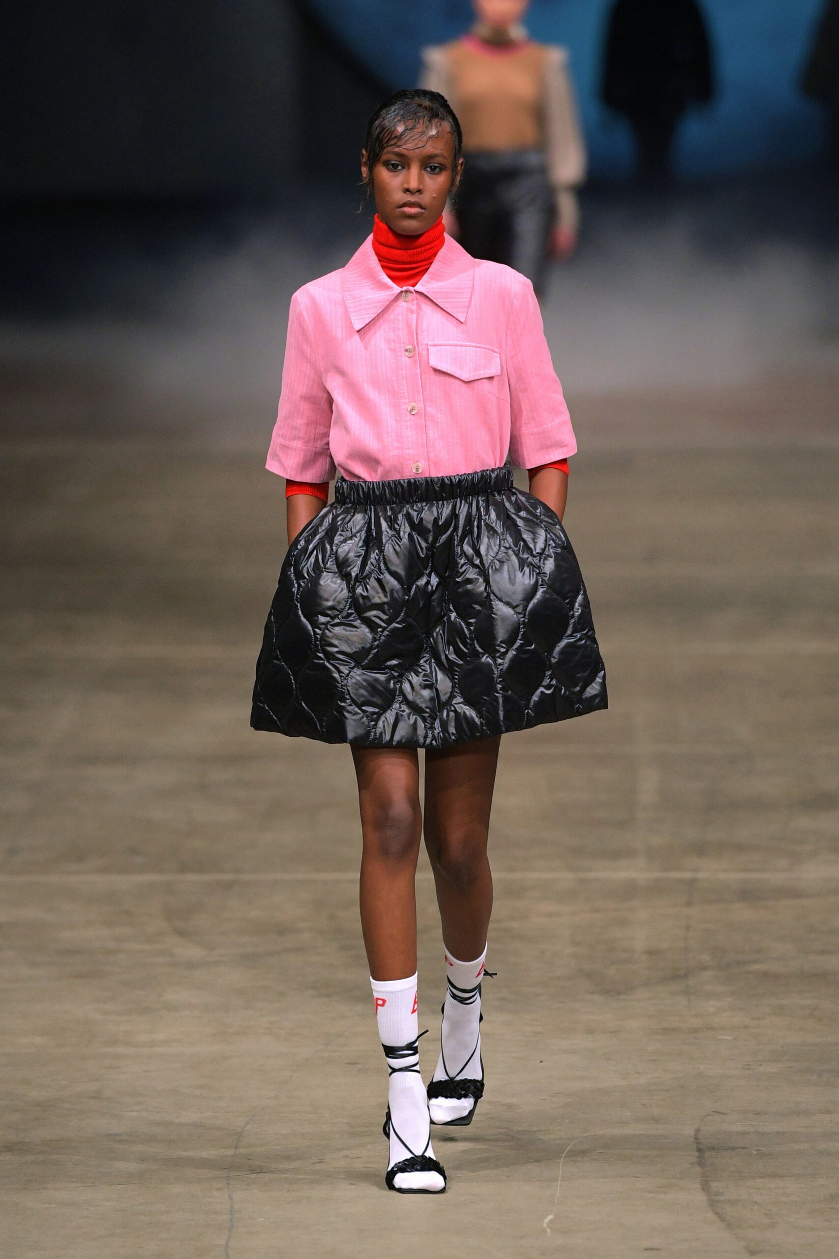 pink collared shirt and black skirt