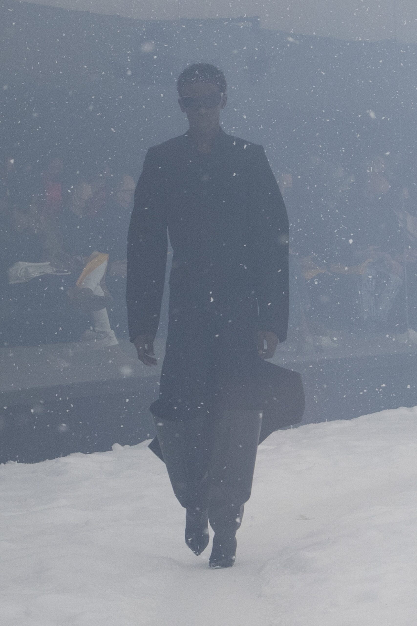 black fitted coat and knee-high boots