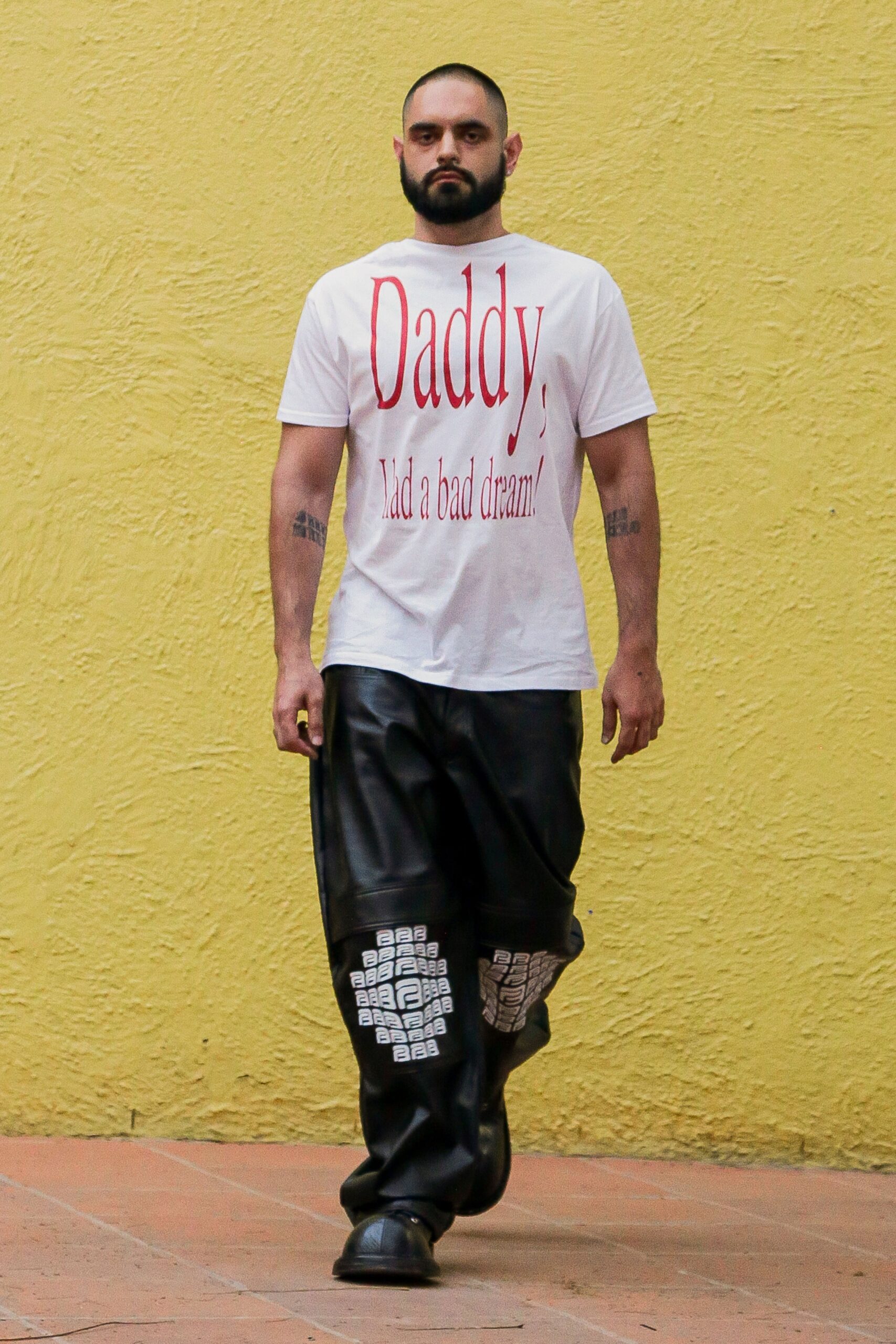 white printed t-shirt and black leather pants