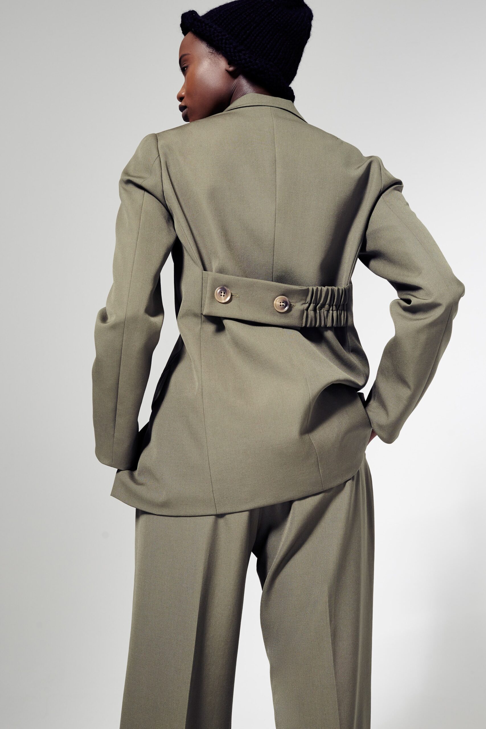 green tailored blazer and relaxed pants