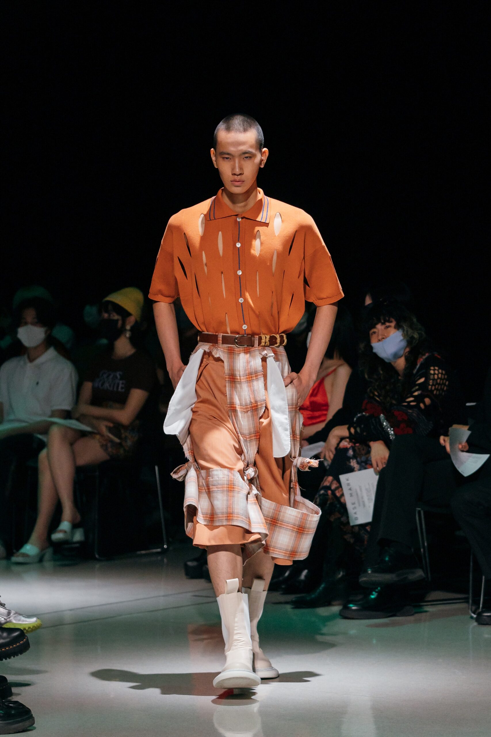 orange distressed shirt with beige pants
