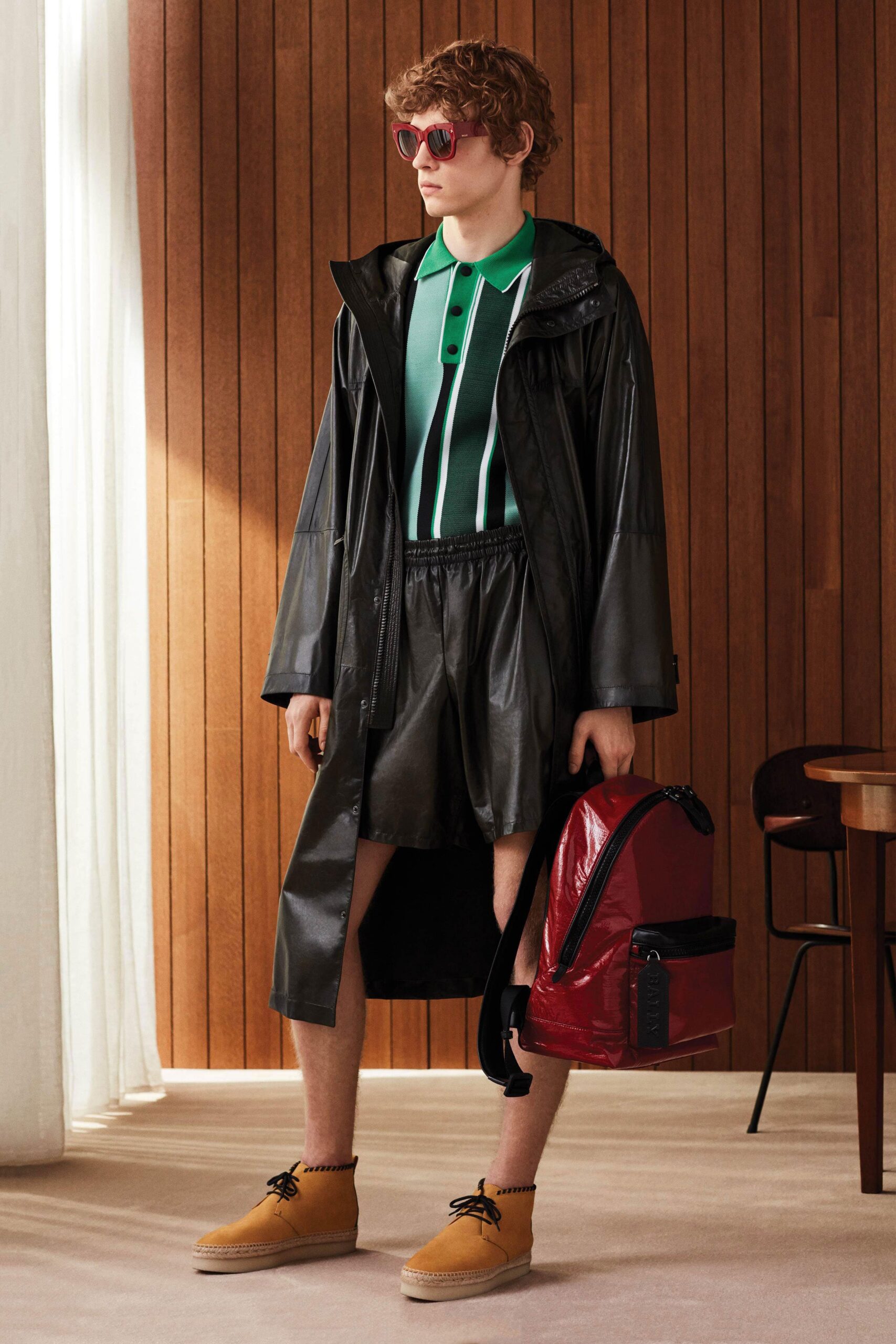 black vinyl coat with green shirt