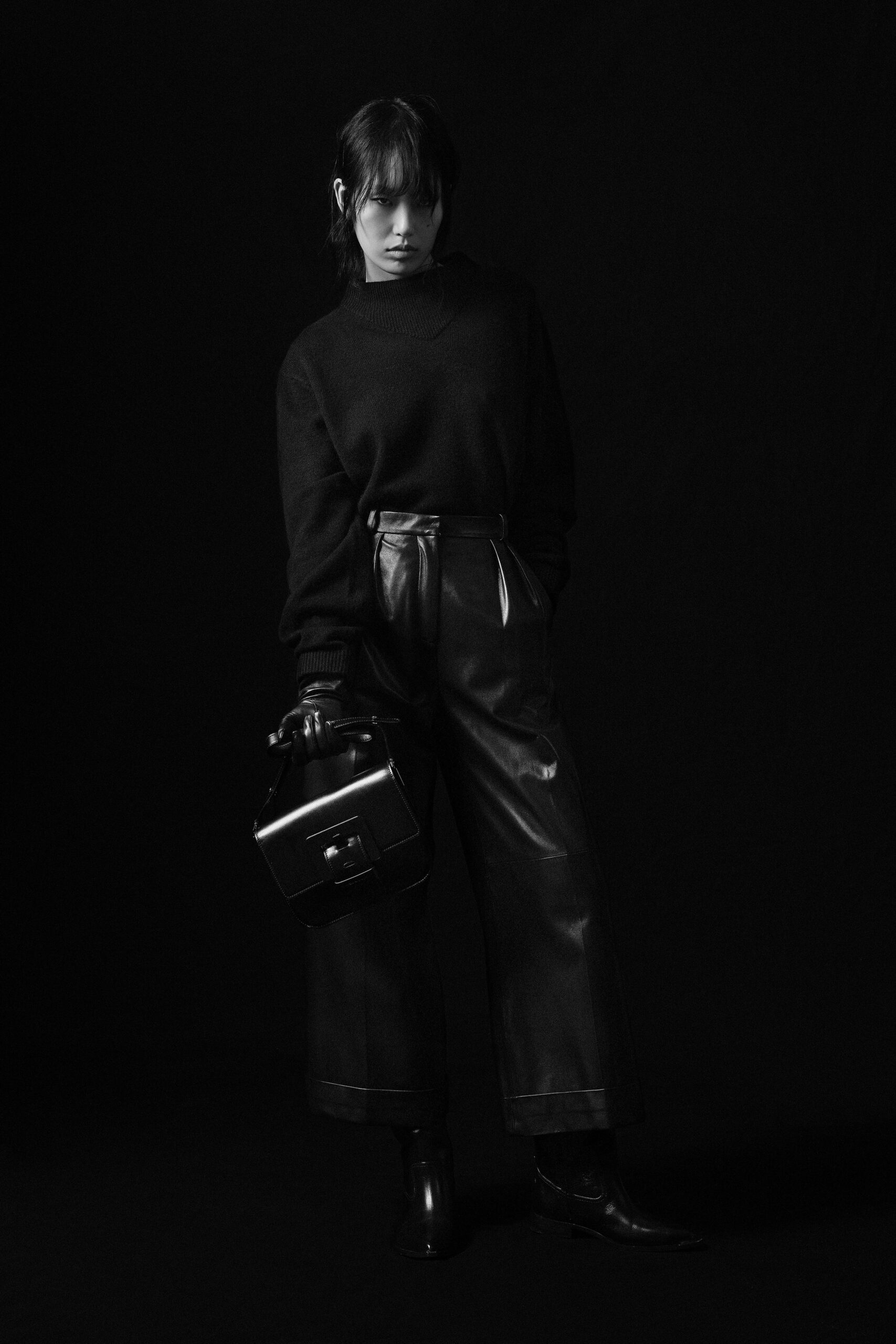 black relaxed sweater and fitted leather pants