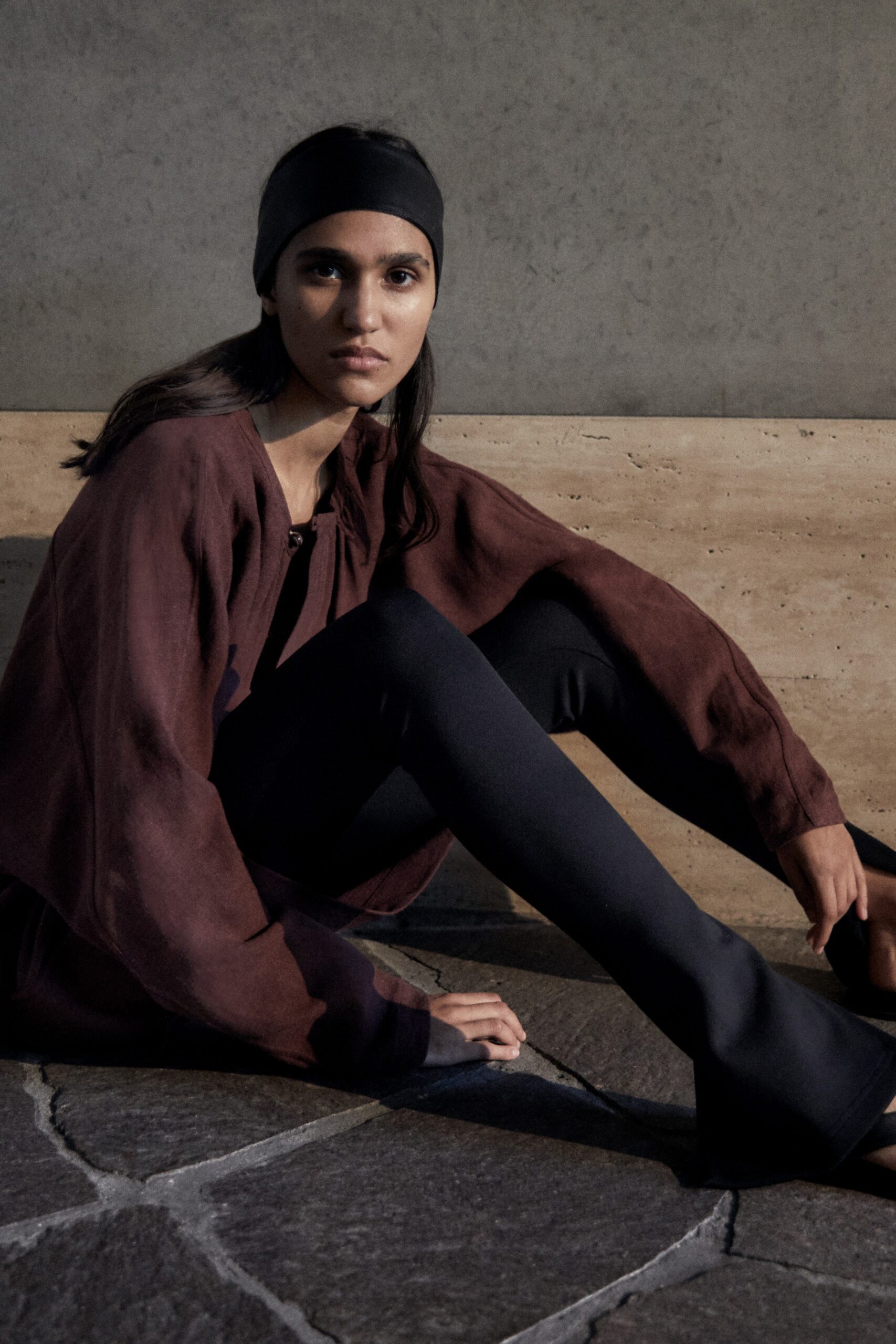 brown relaxed top with black flared pants