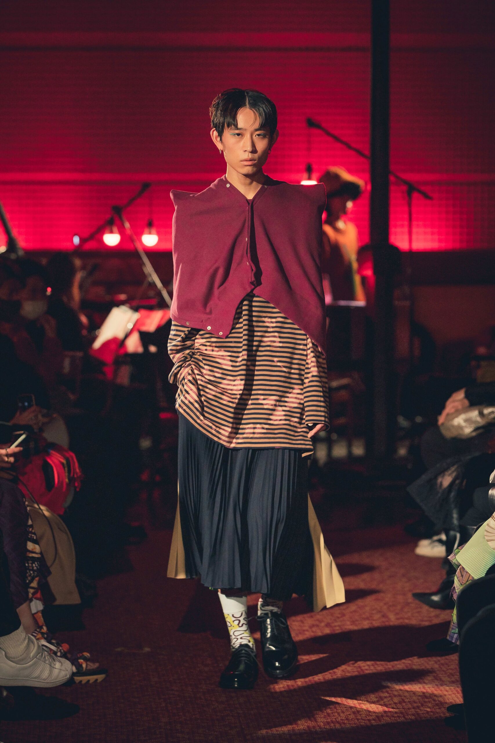 purple cape with striped top and pleated skirt