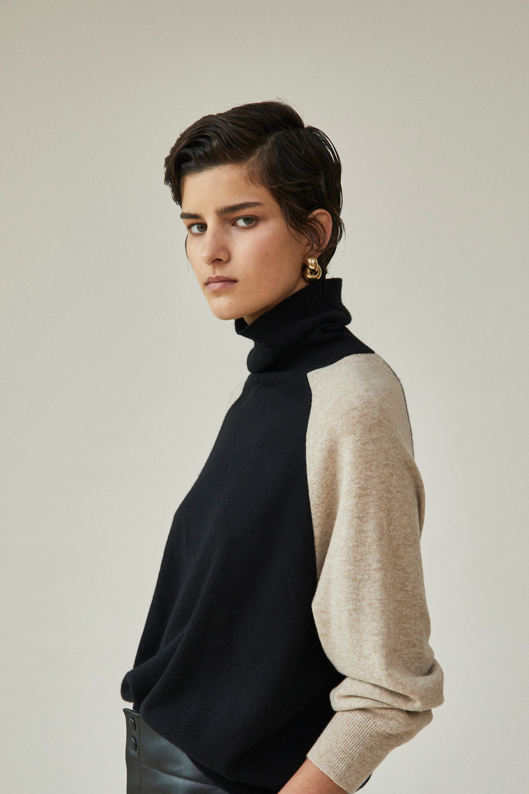 black and beige wool sweater with leather pants