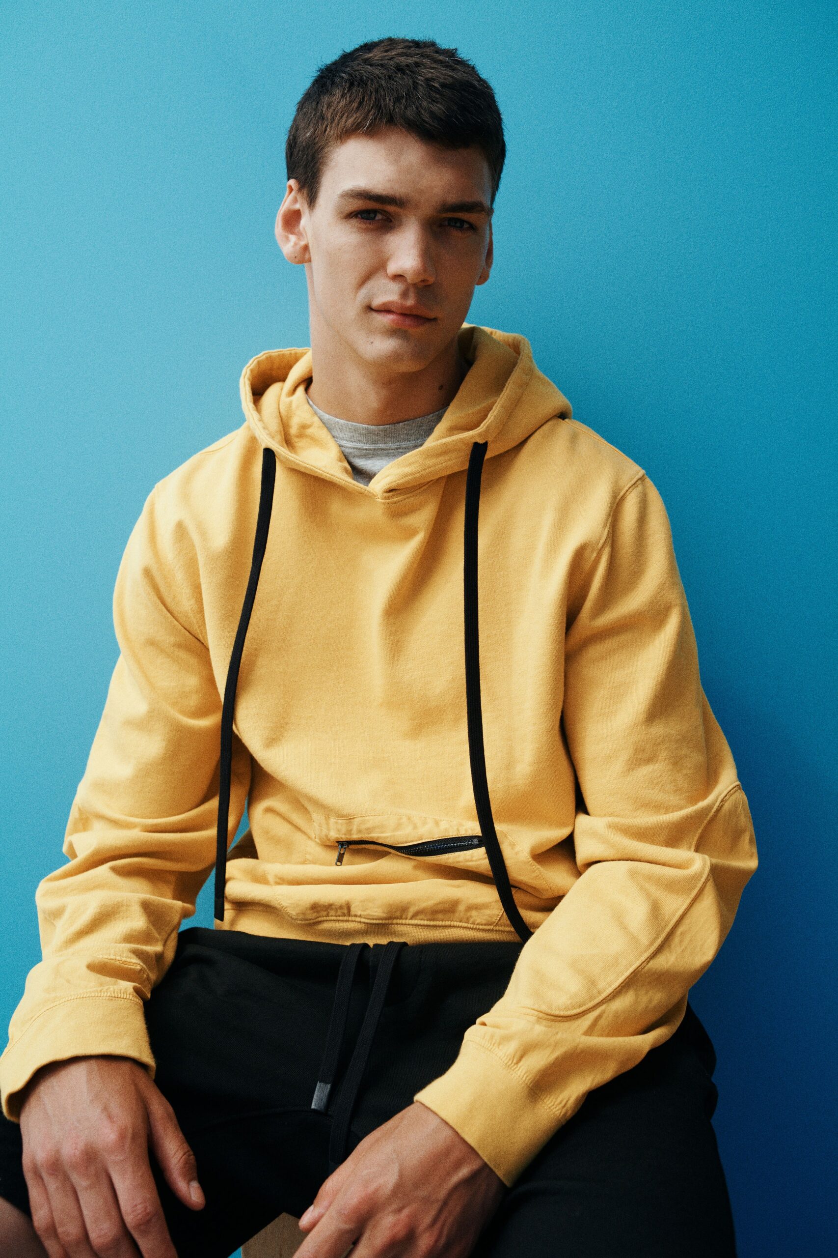 yellow hoodie and black shorts