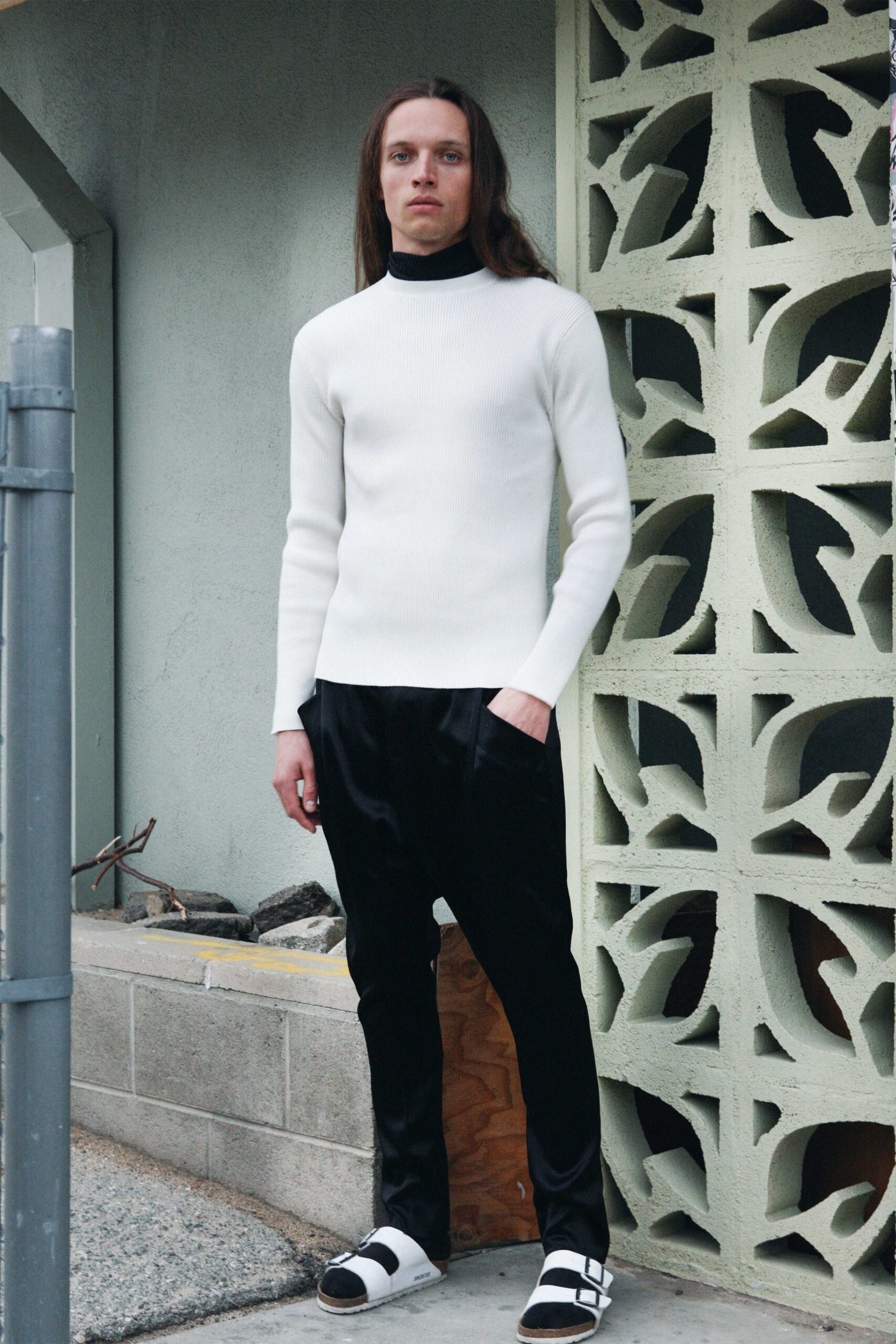 white fitted sweater and black pants