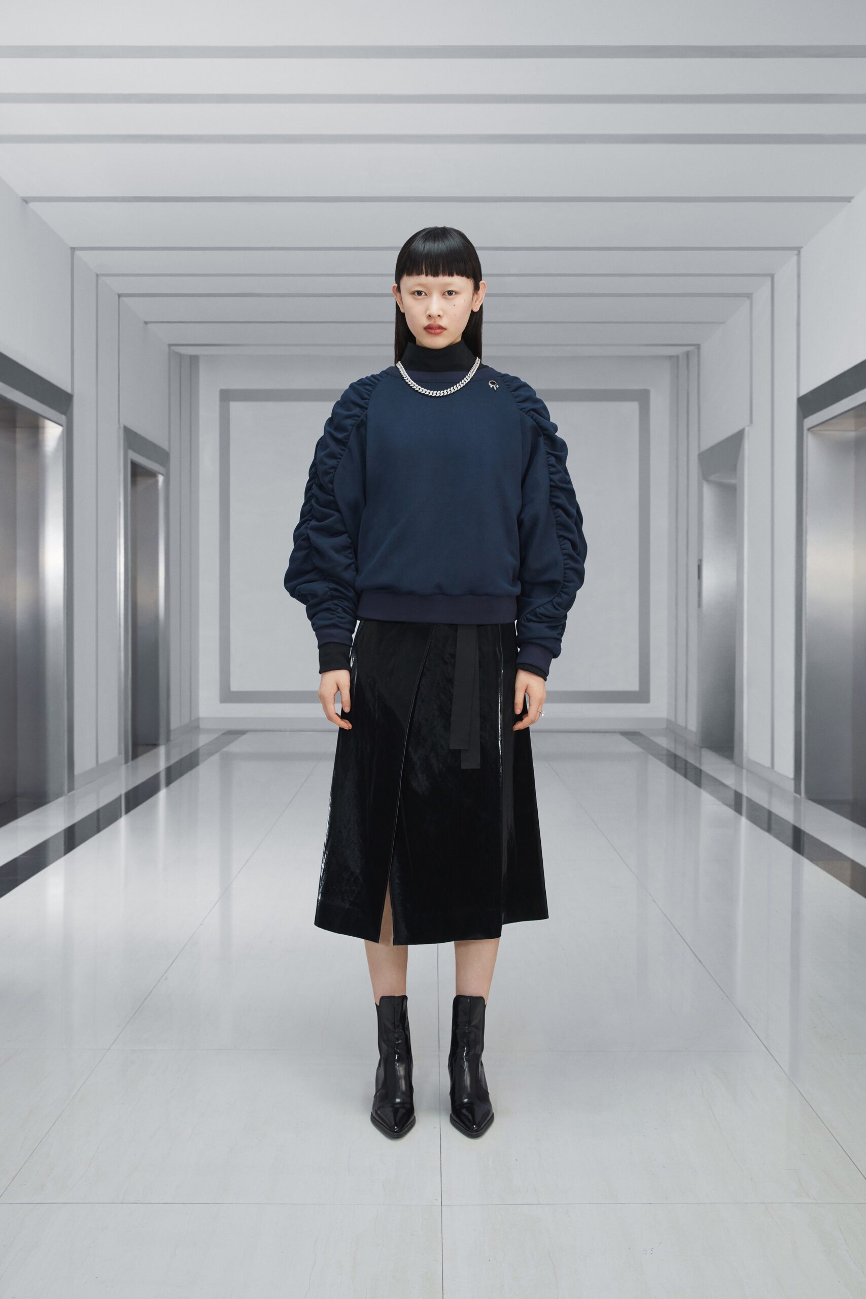 blue fitted sweater with black skirt