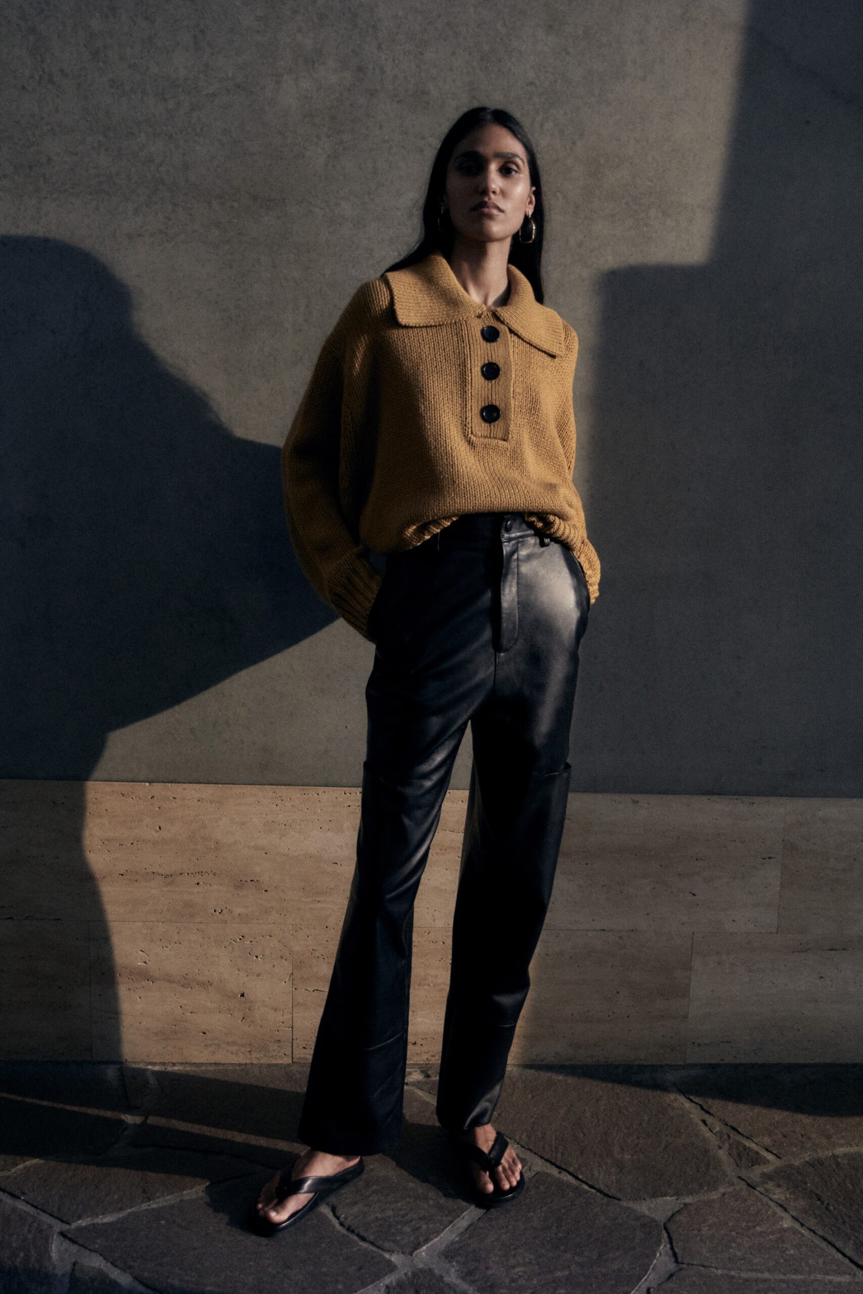 yellow wool relaxed sweater and black leather pants