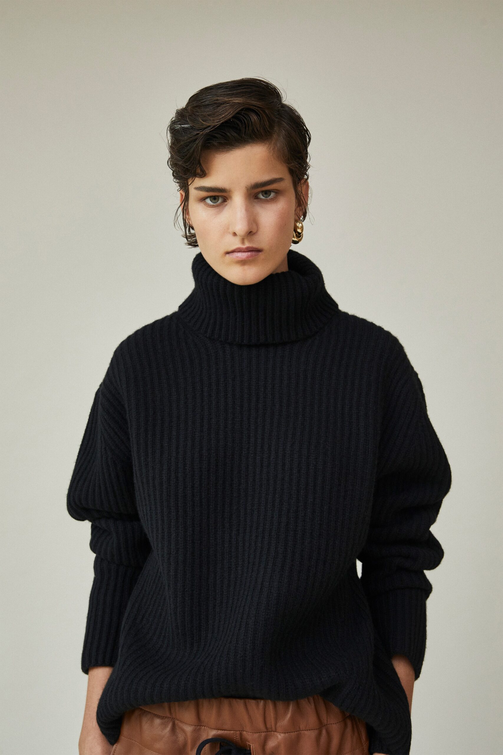 black oversized sweater with brown leather pants