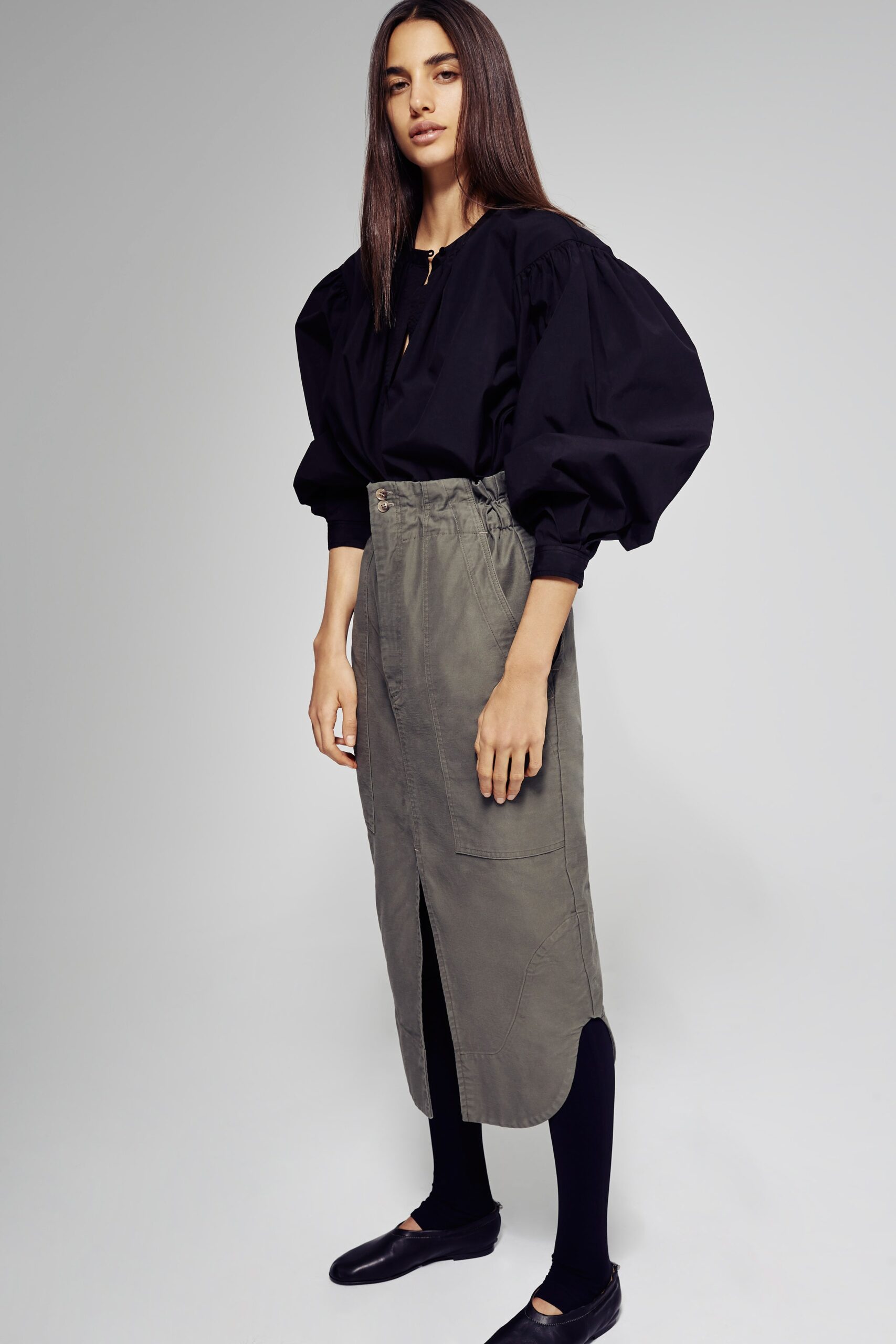 black relaxed top with green skirt