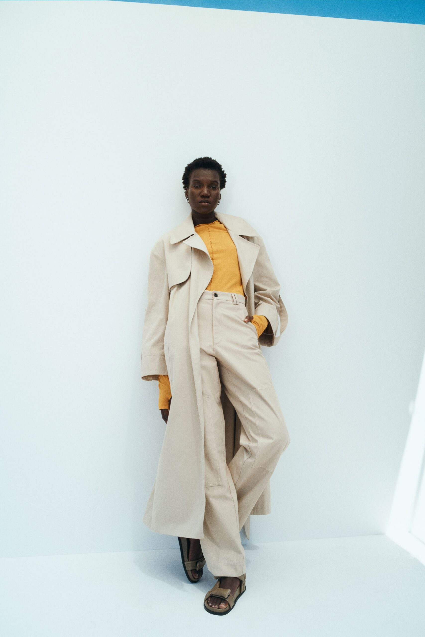 beige coat with yellow top