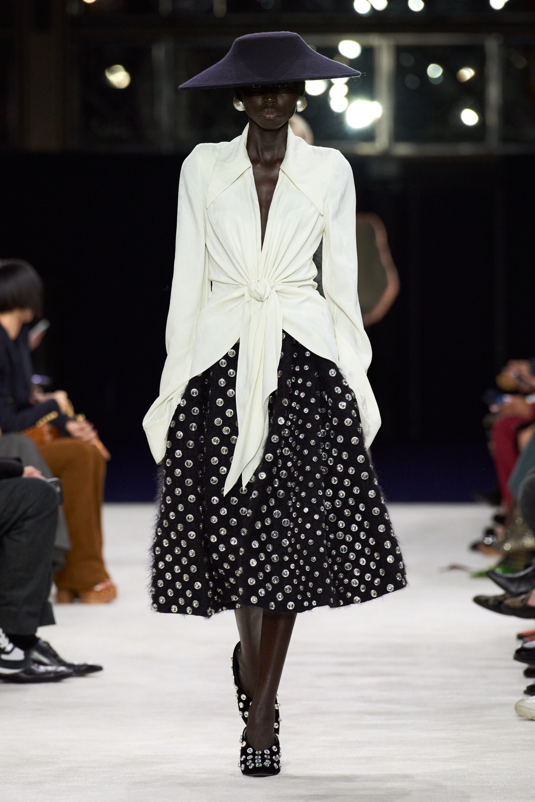 white silk blouse black pleated skirt