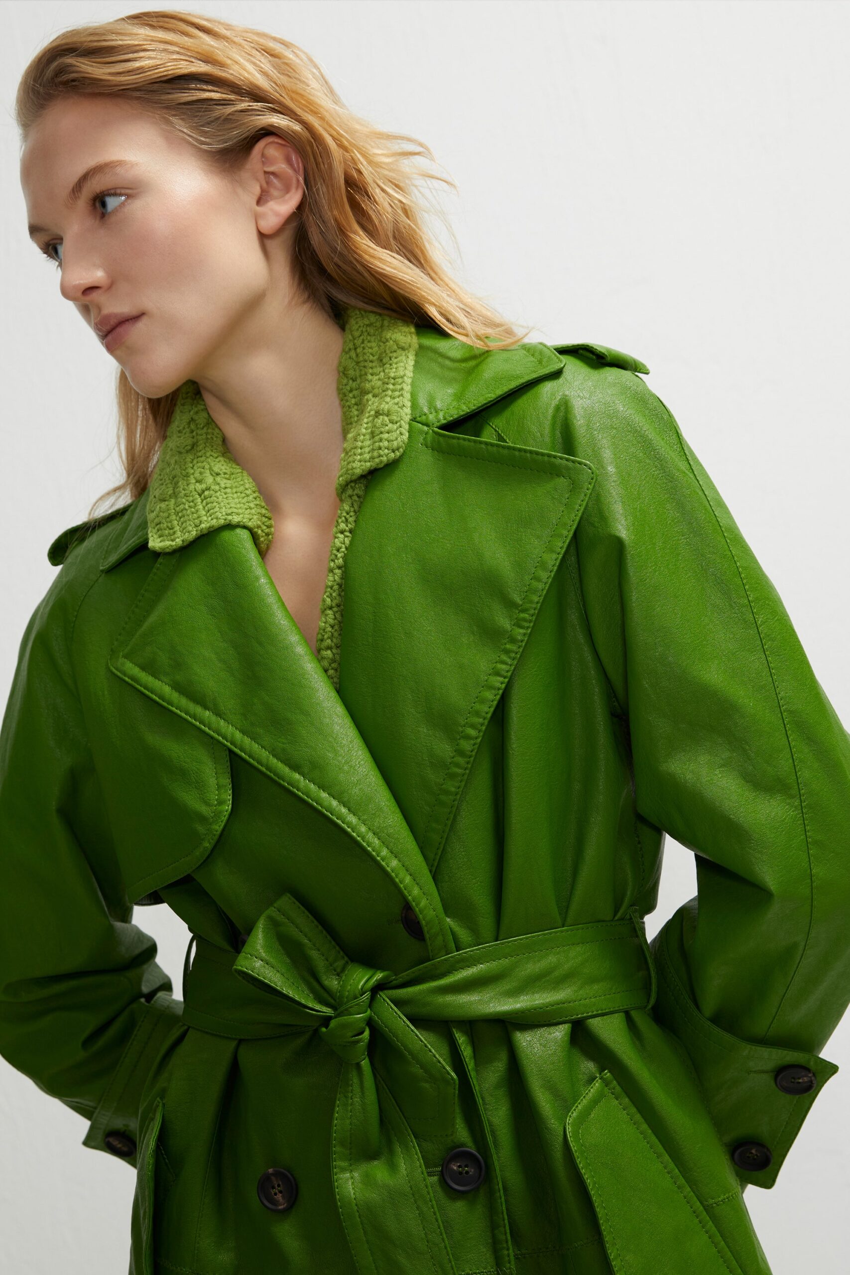 green leather trench coat and knit top